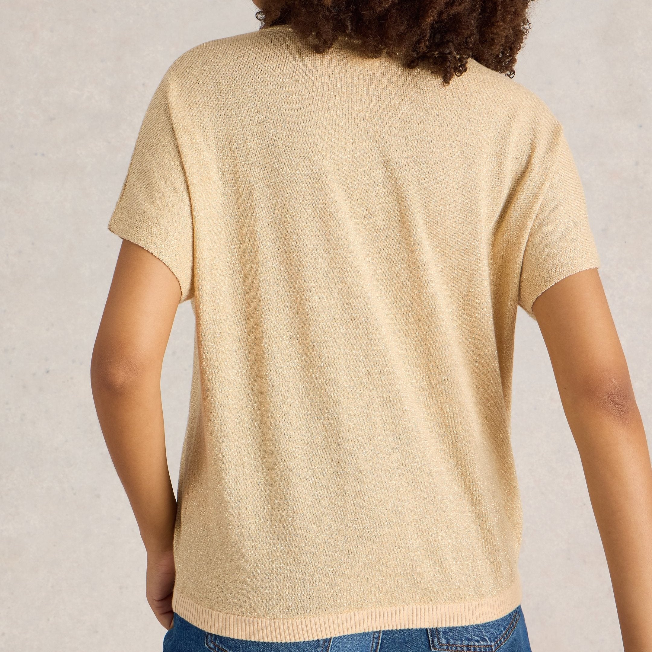 Pale gold short-sleeve knit sweater with a ribbed hem.