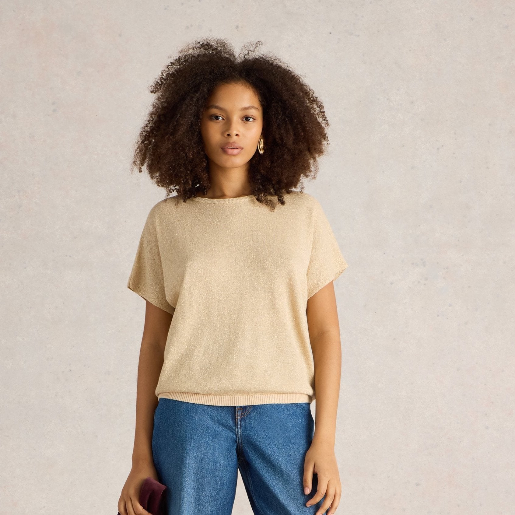 Beige sparkly knit short-sleeved top with a relaxed fit.