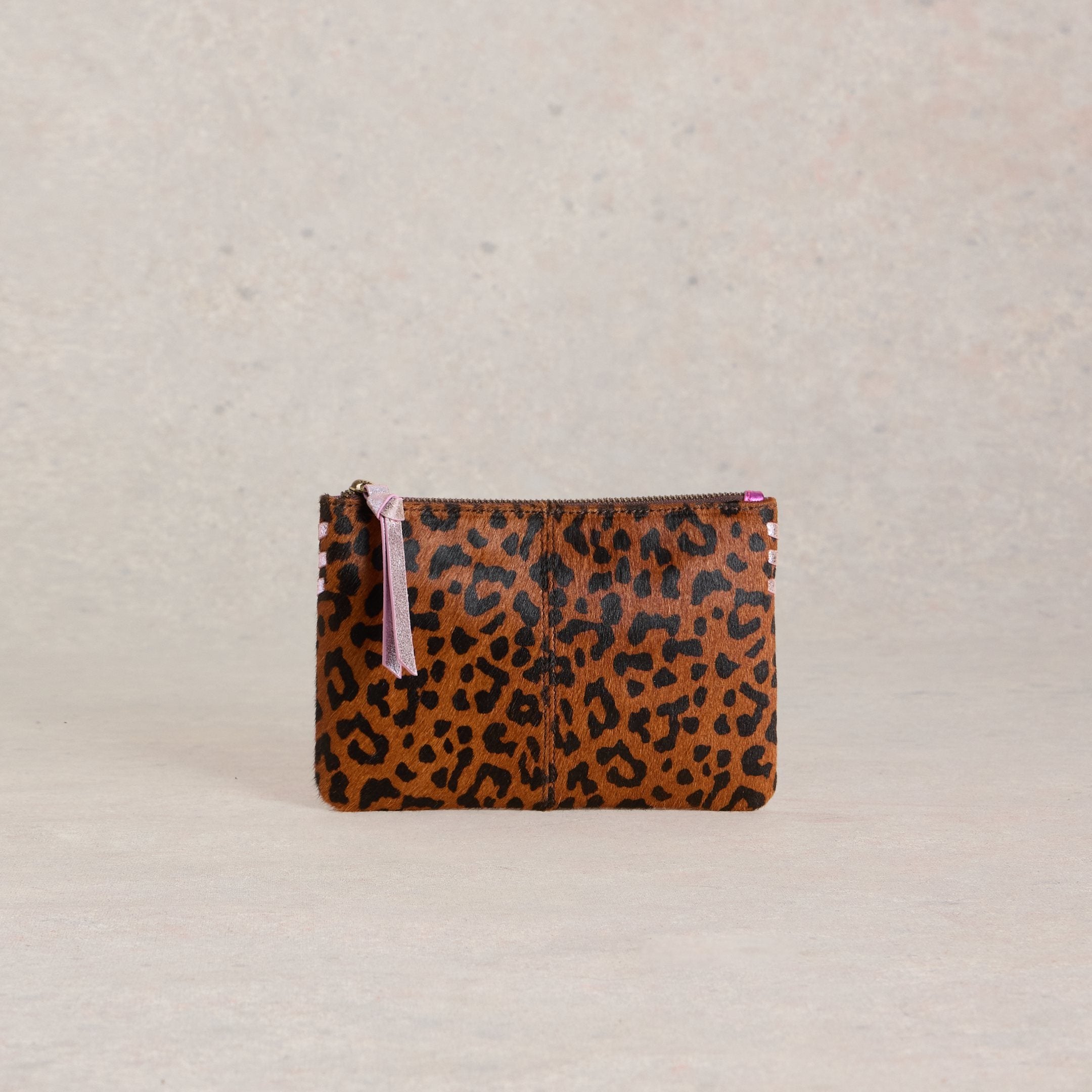 Brown and black leopard print calf hair zipped pouch with a light purple zipper pull.