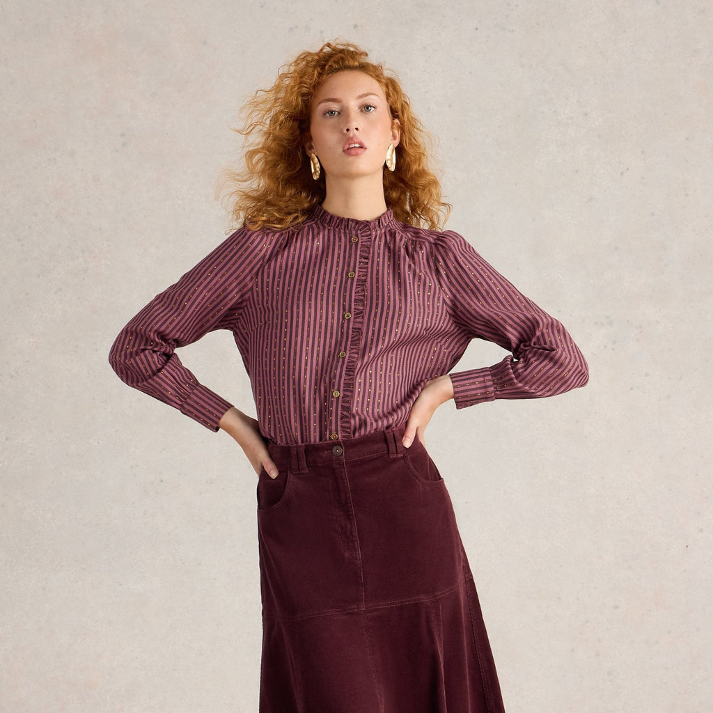 Burgundy striped long-sleeve blouse with gold accents, paired with a maroon corduroy A-line midi skirt.