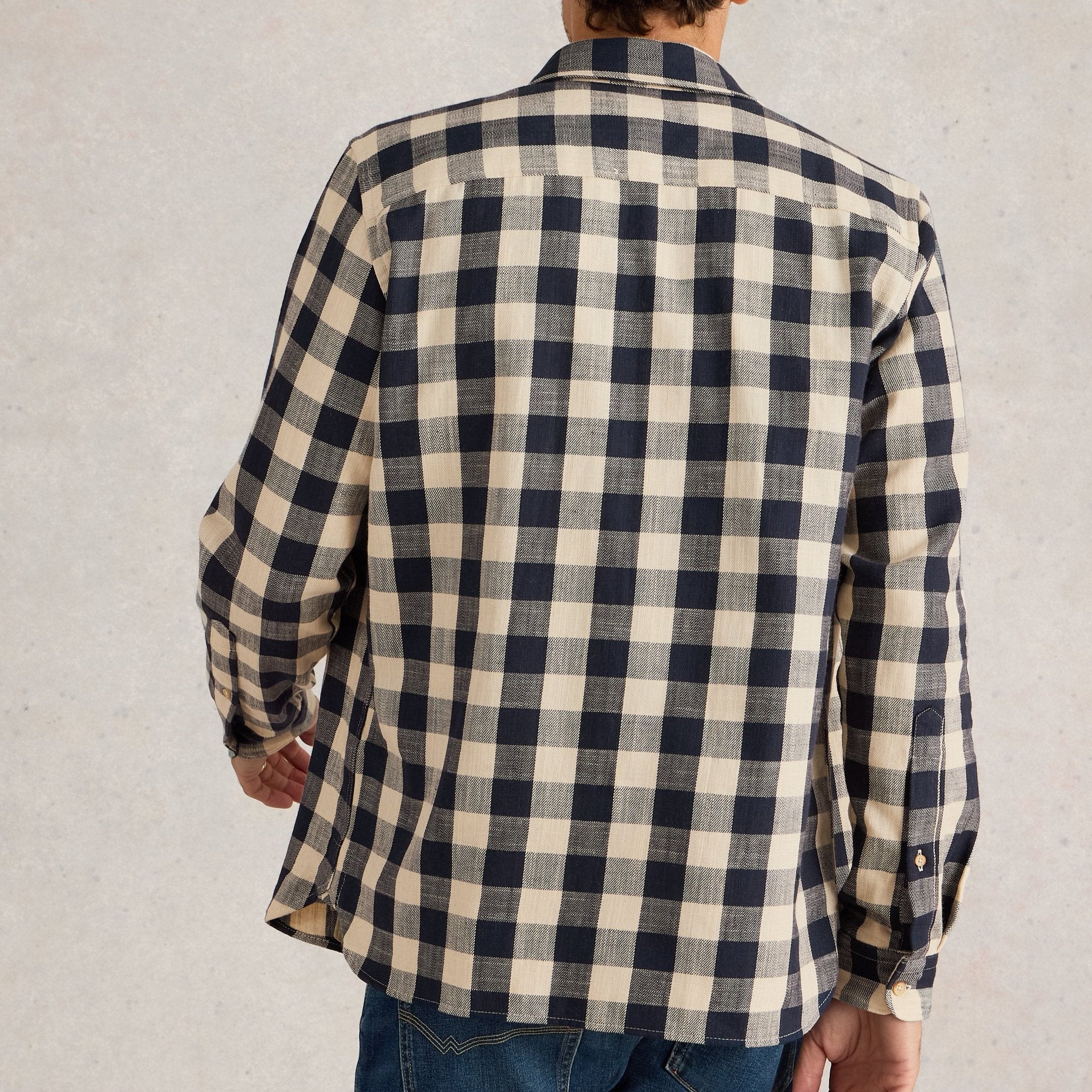 Rear view of a beige and navy blue buffalo plaid long-sleeve button-down shirt.