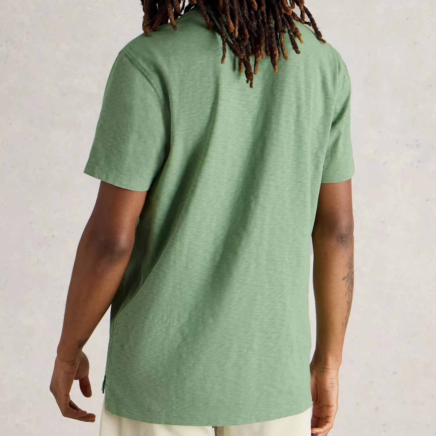 Sage green short-sleeve t-shirt with a textured, slightly slubbed fabric.