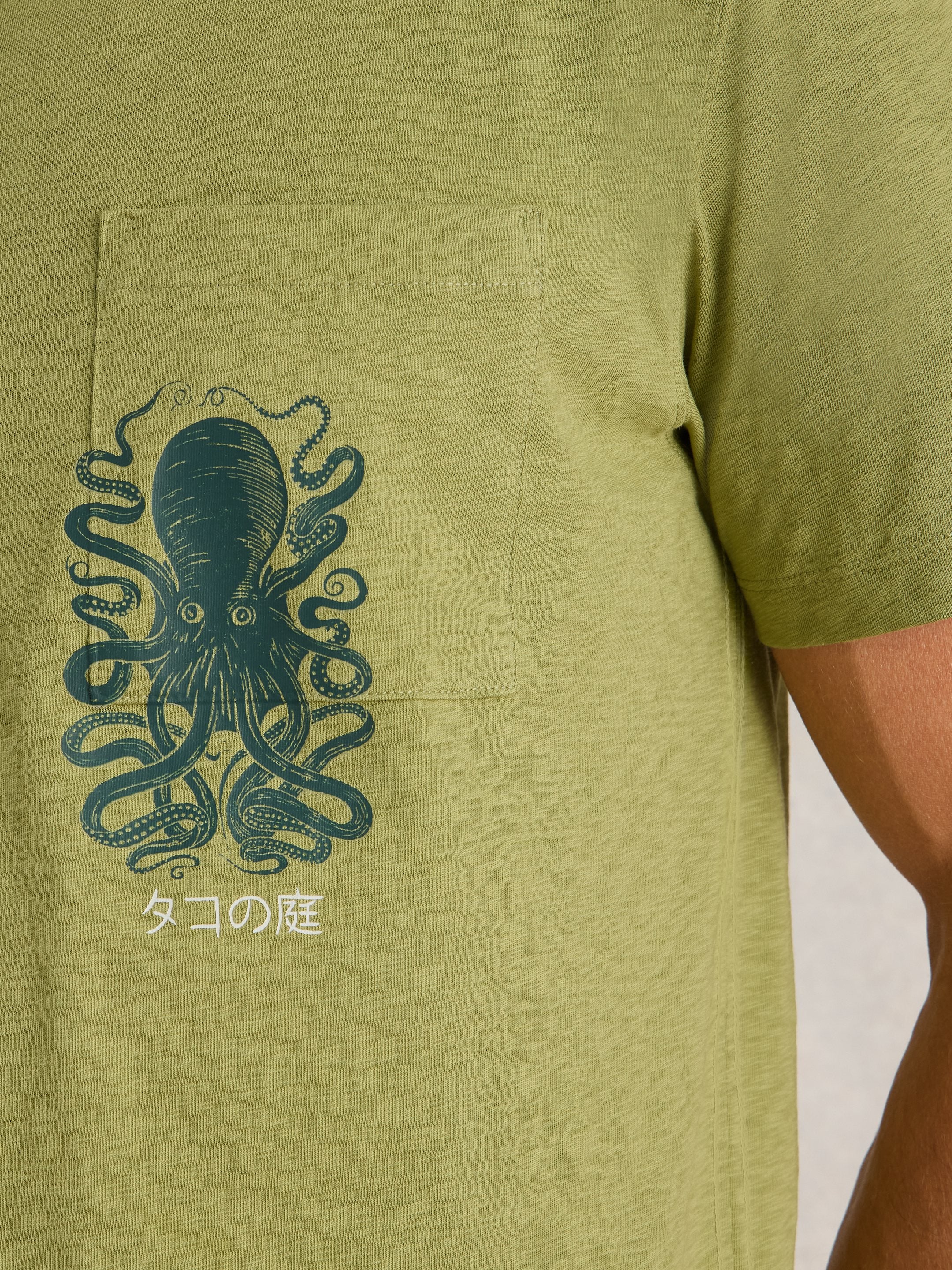 Olive green t-shirt with a dark green octopus graphic on the chest pocket.