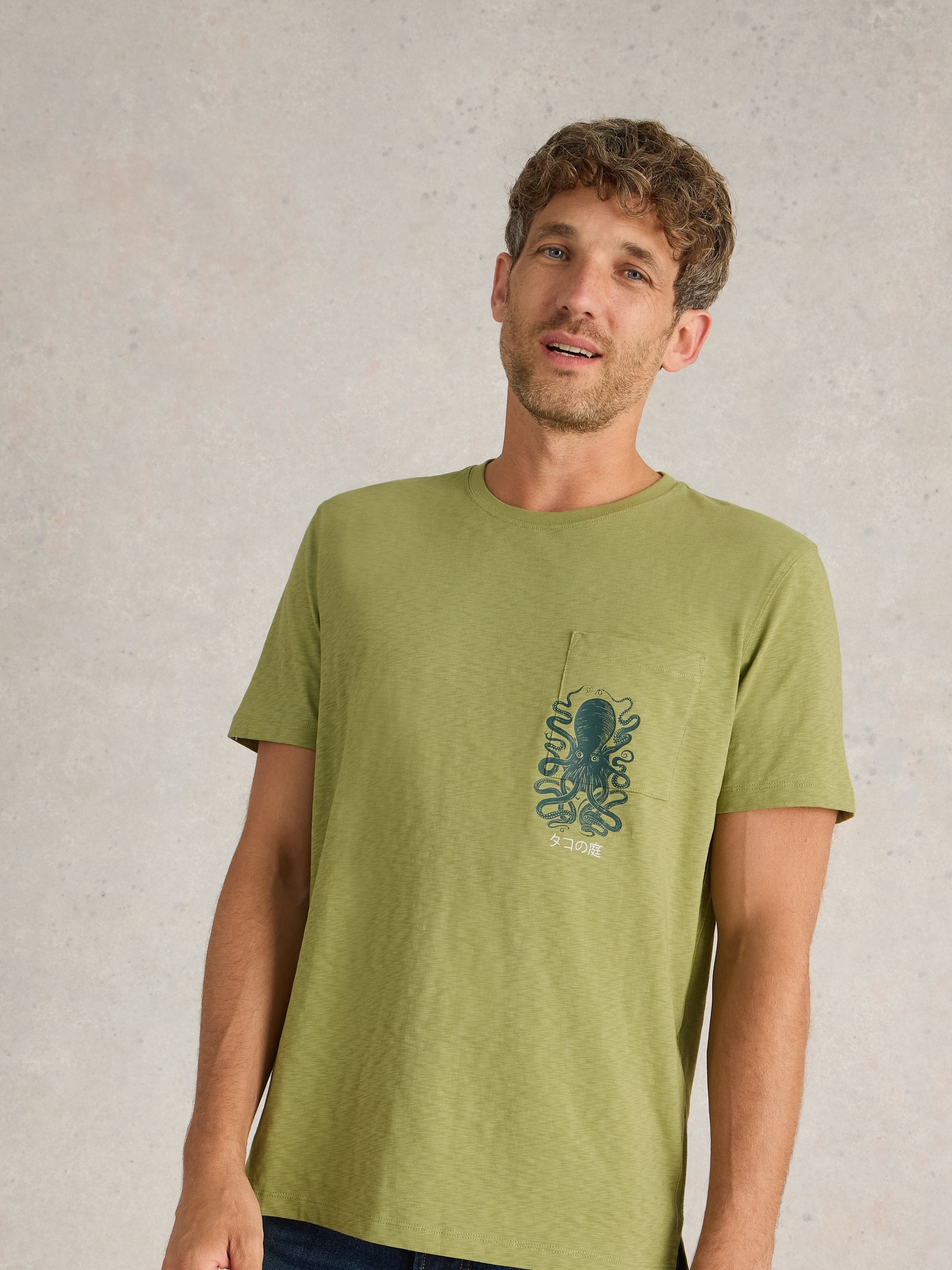 Olive green short-sleeve t-shirt with a pocket featuring an octopus graphic and Japanese text.