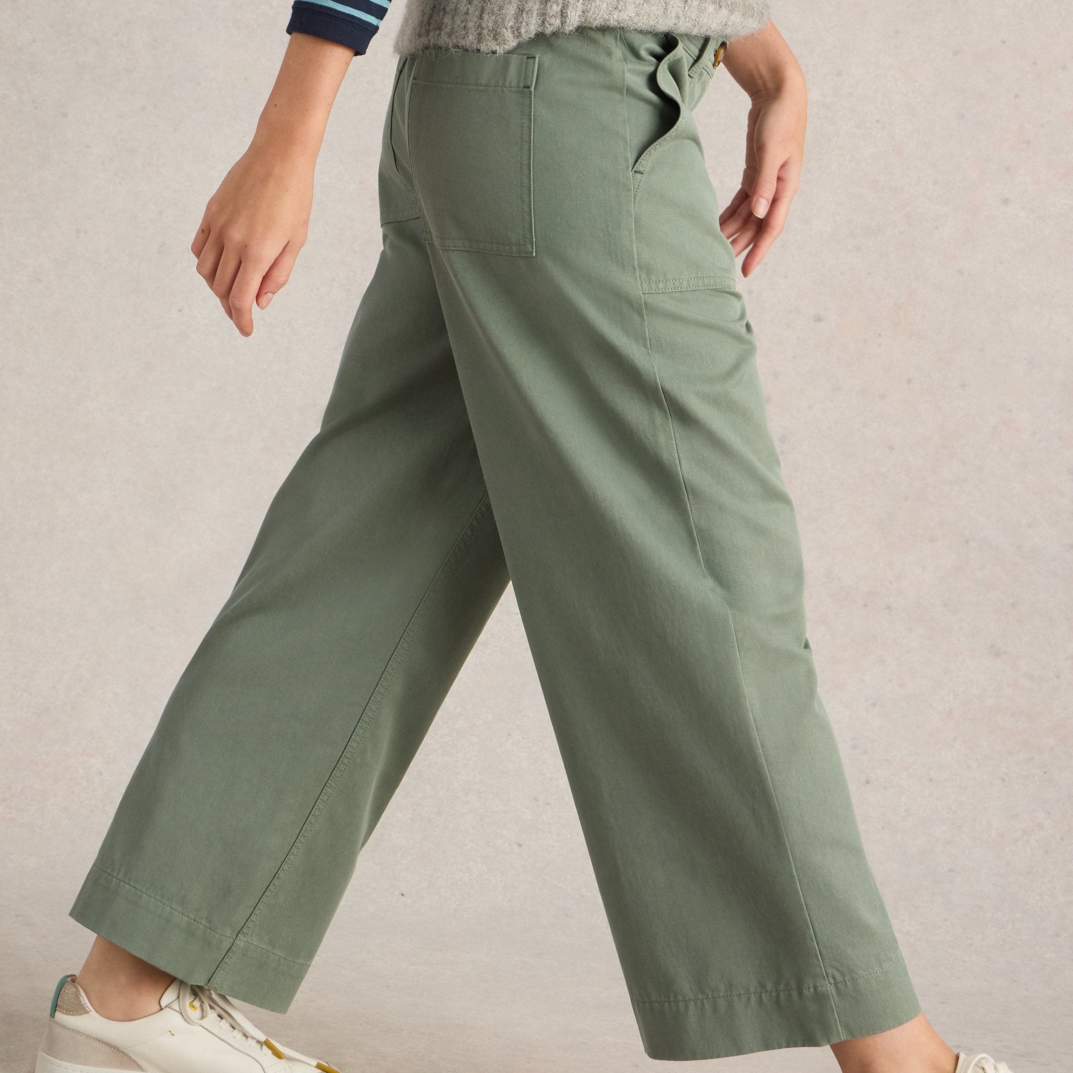 Sage green wide-leg cropped pants with front and back pockets.
