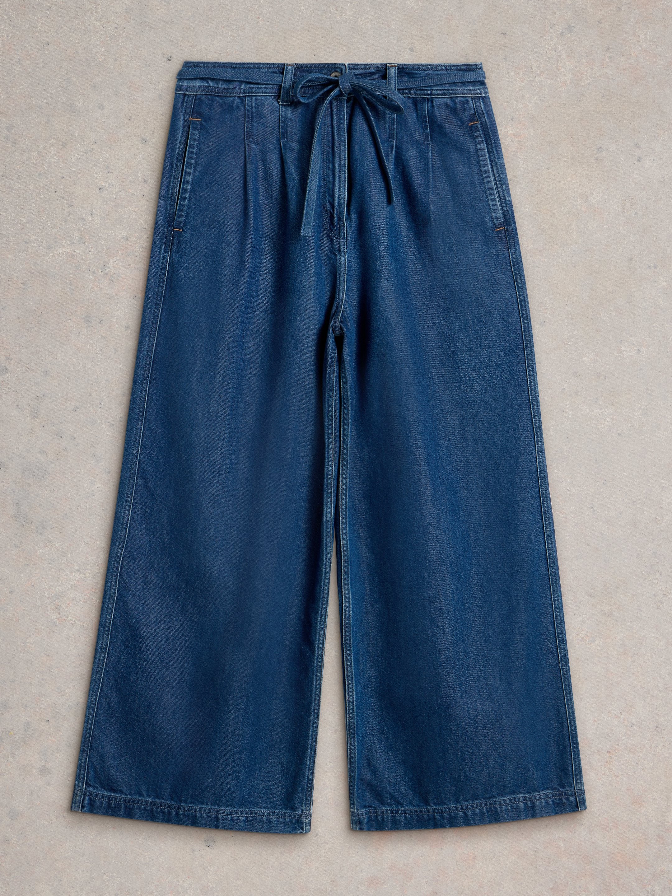 Dark wash denim wide-leg pants with a drawstring waist.