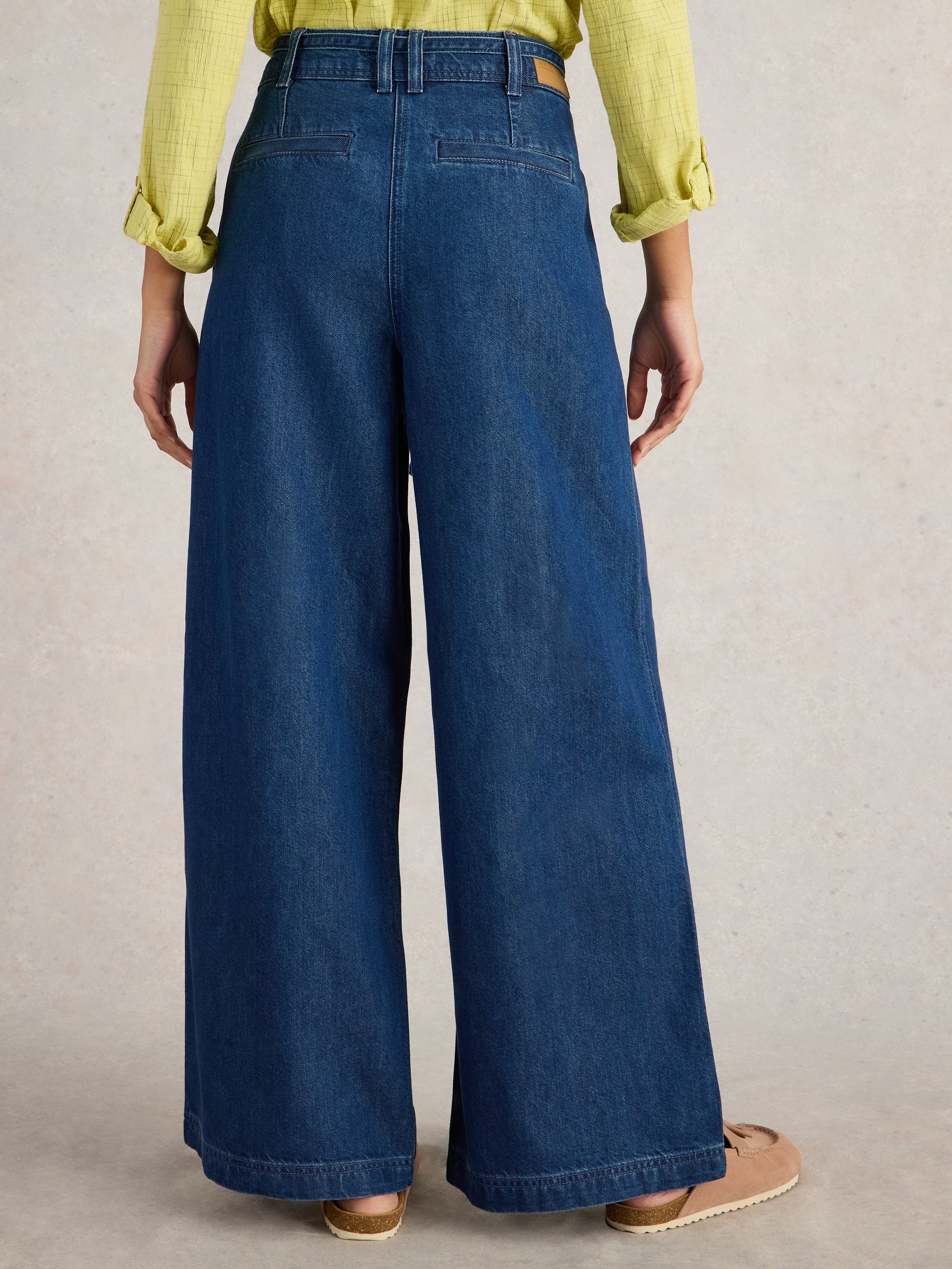Dark wash wide-leg denim pants with a high waist and belt loops. The pants have a relaxed fit and a straight hem.