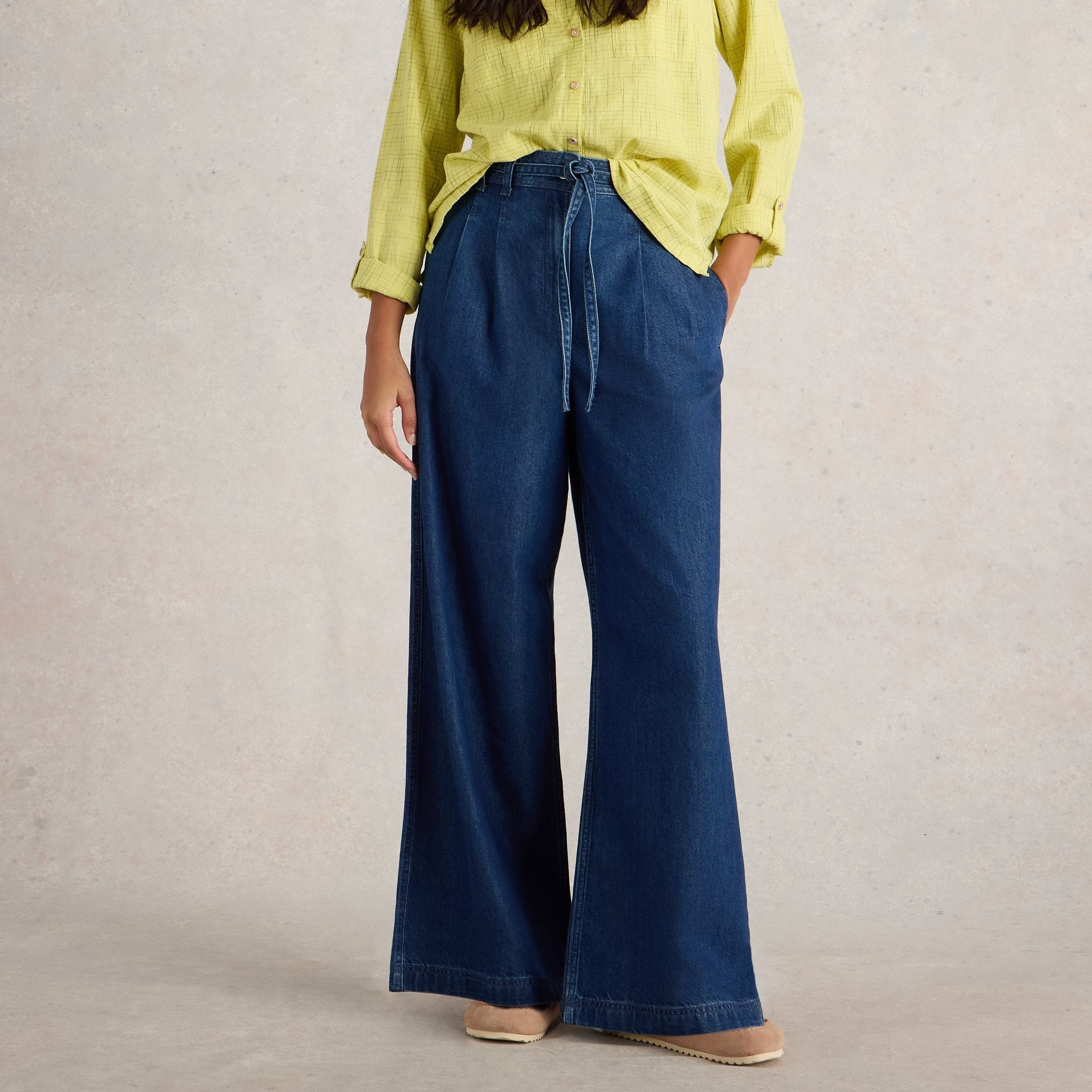 Dark wash wide-leg denim pants with a drawstring waist.