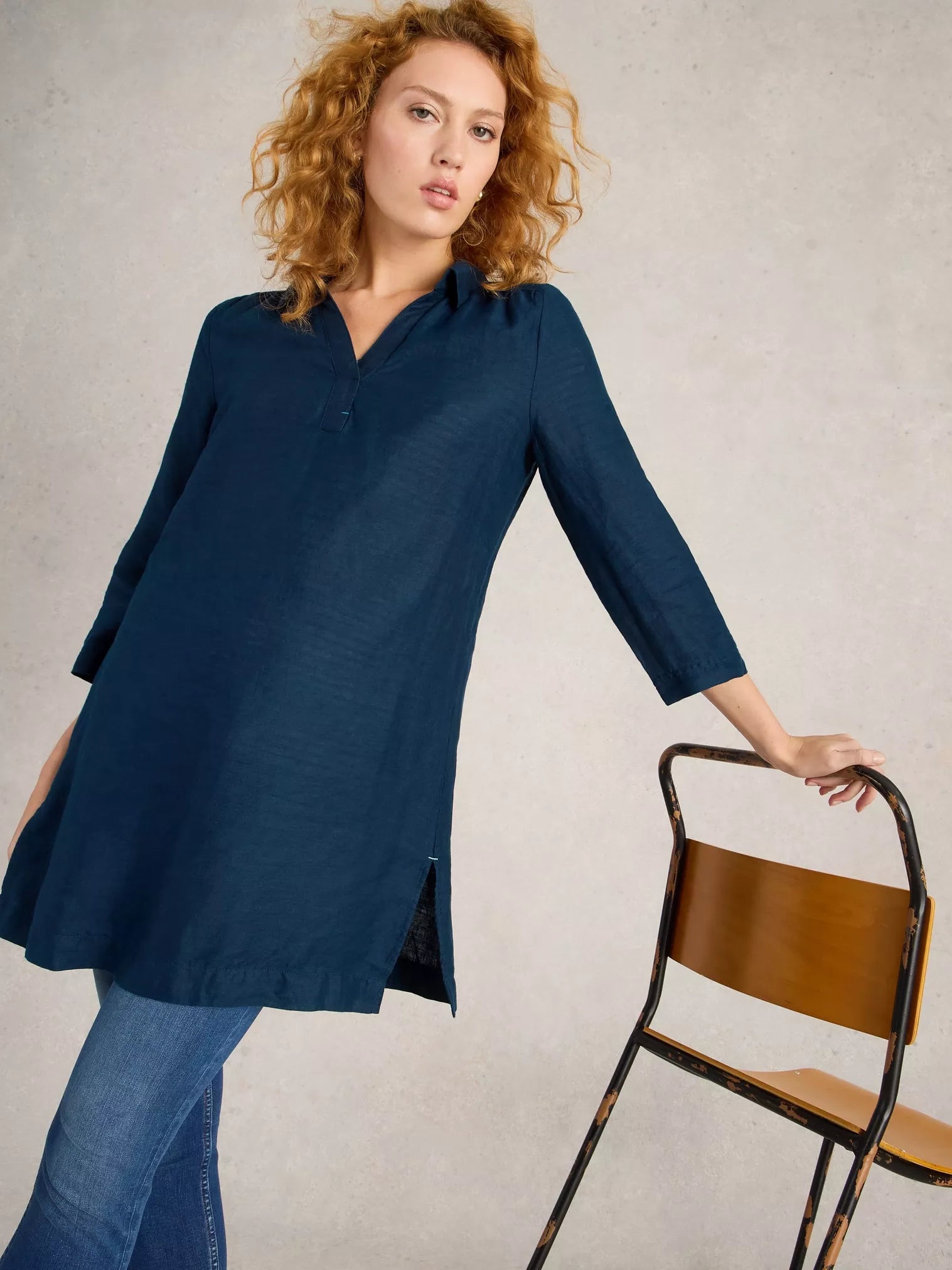 Dark teal linen tunic with a collared neckline and side slits. Three-quarter sleeves.