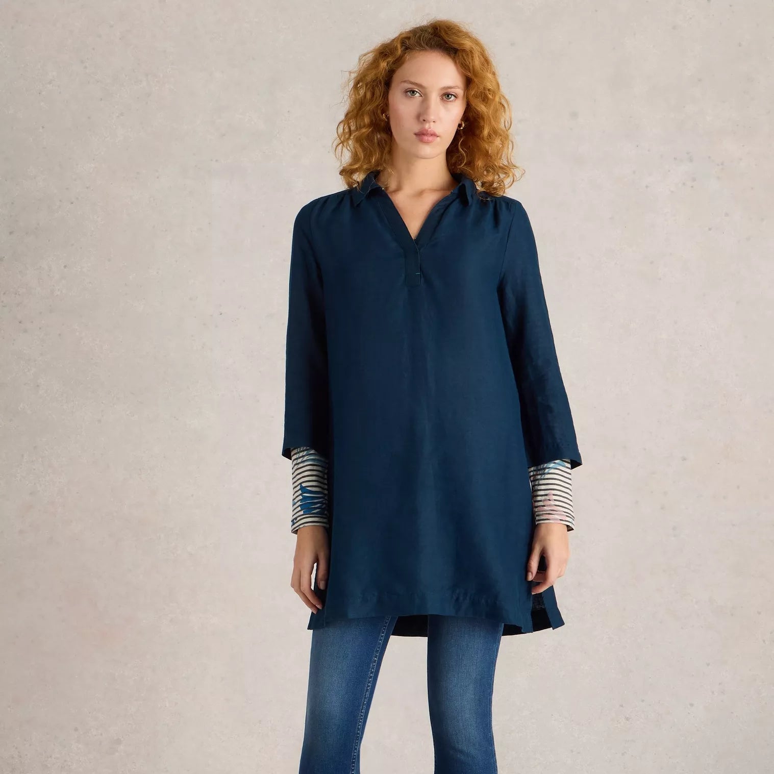 Dark teal linen tunic with a collared neckline and three-quarter sleeves.