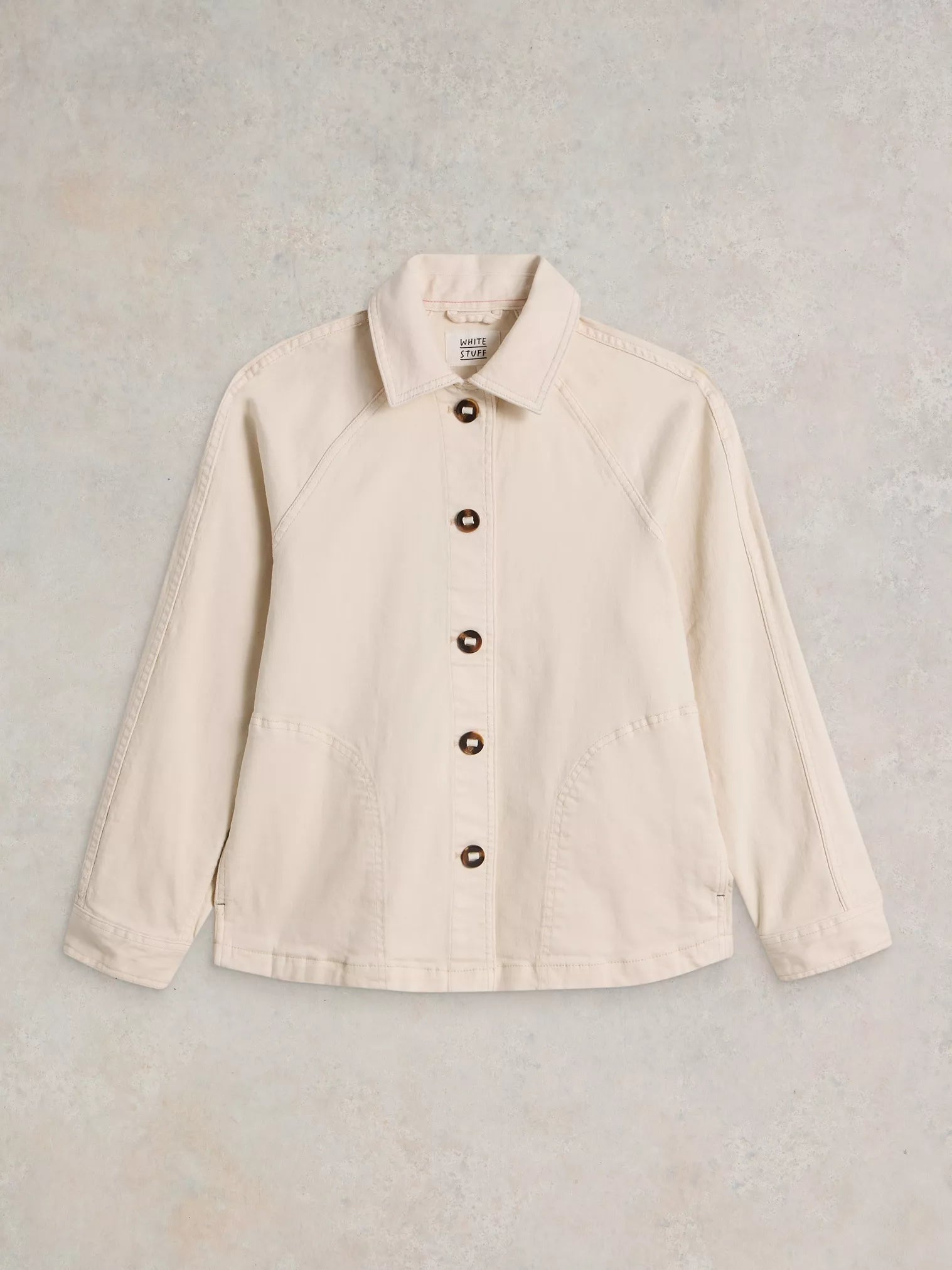 Beige jacket with buttons on a light gray background
