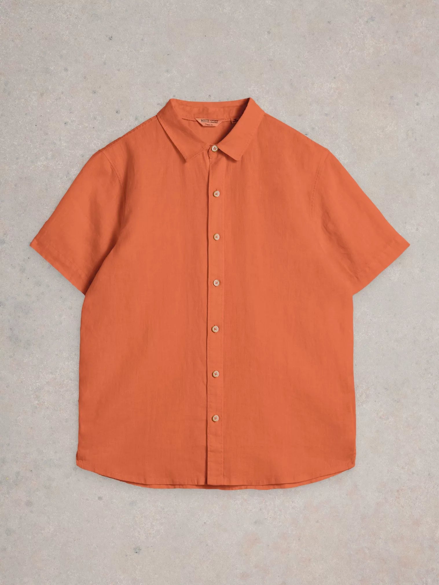 Burnt orange linen short-sleeve button-down shirt.