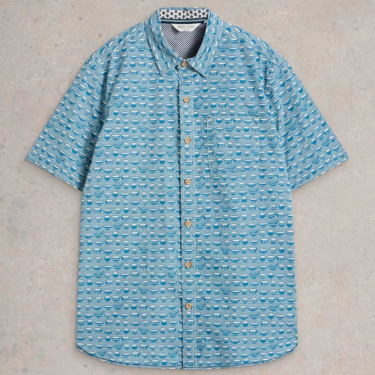 Teal short-sleeved button-down shirt with a repeating pattern of small bowls.