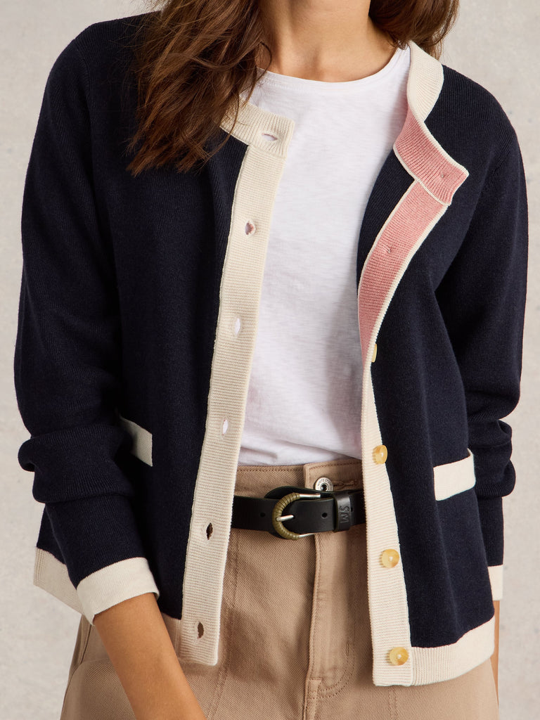 Navy blue cardigan with cream and blush pink trim, button front closure.