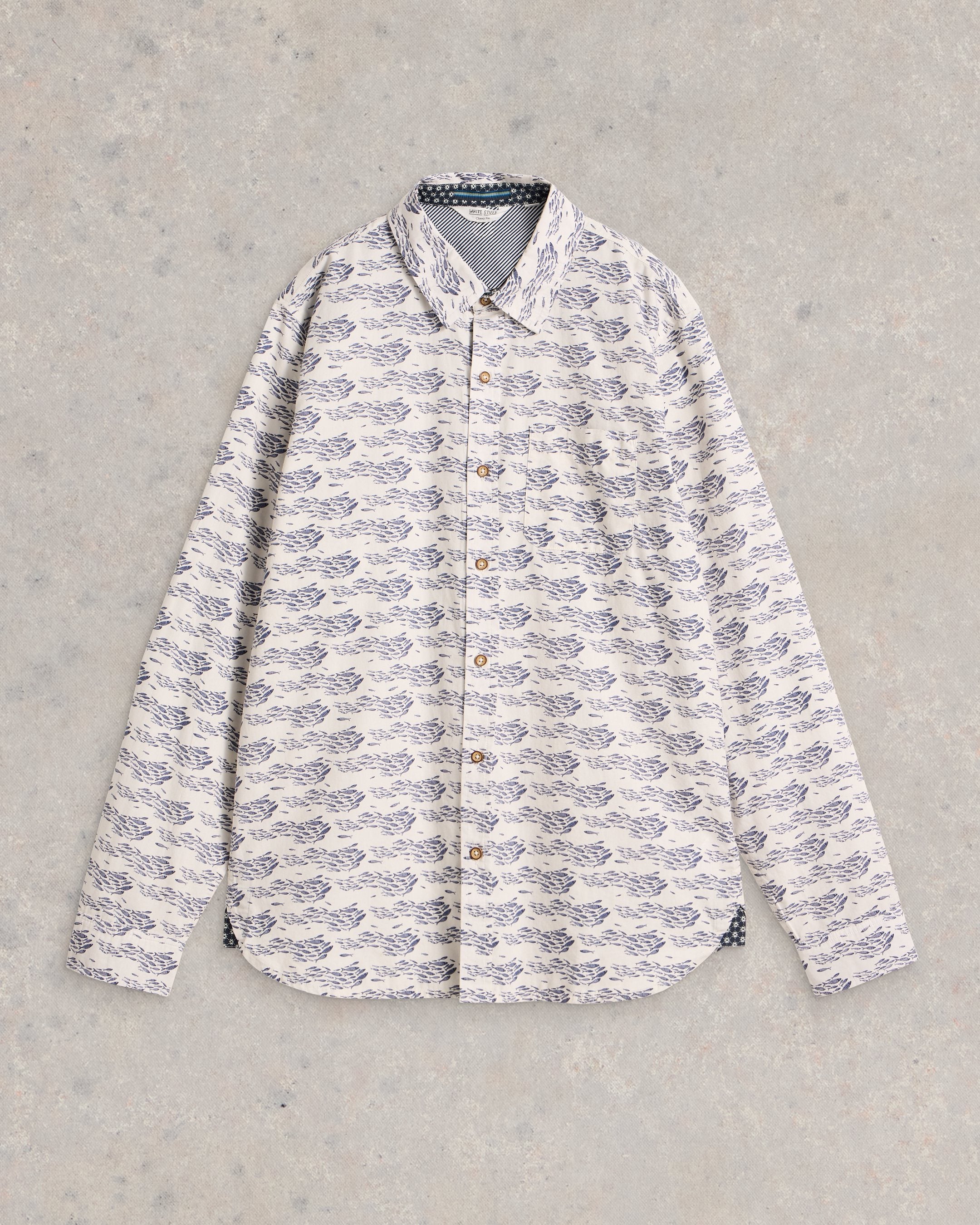 Off-white long-sleeve button-down shirt with a repeating pattern of dark blue schools of fish.