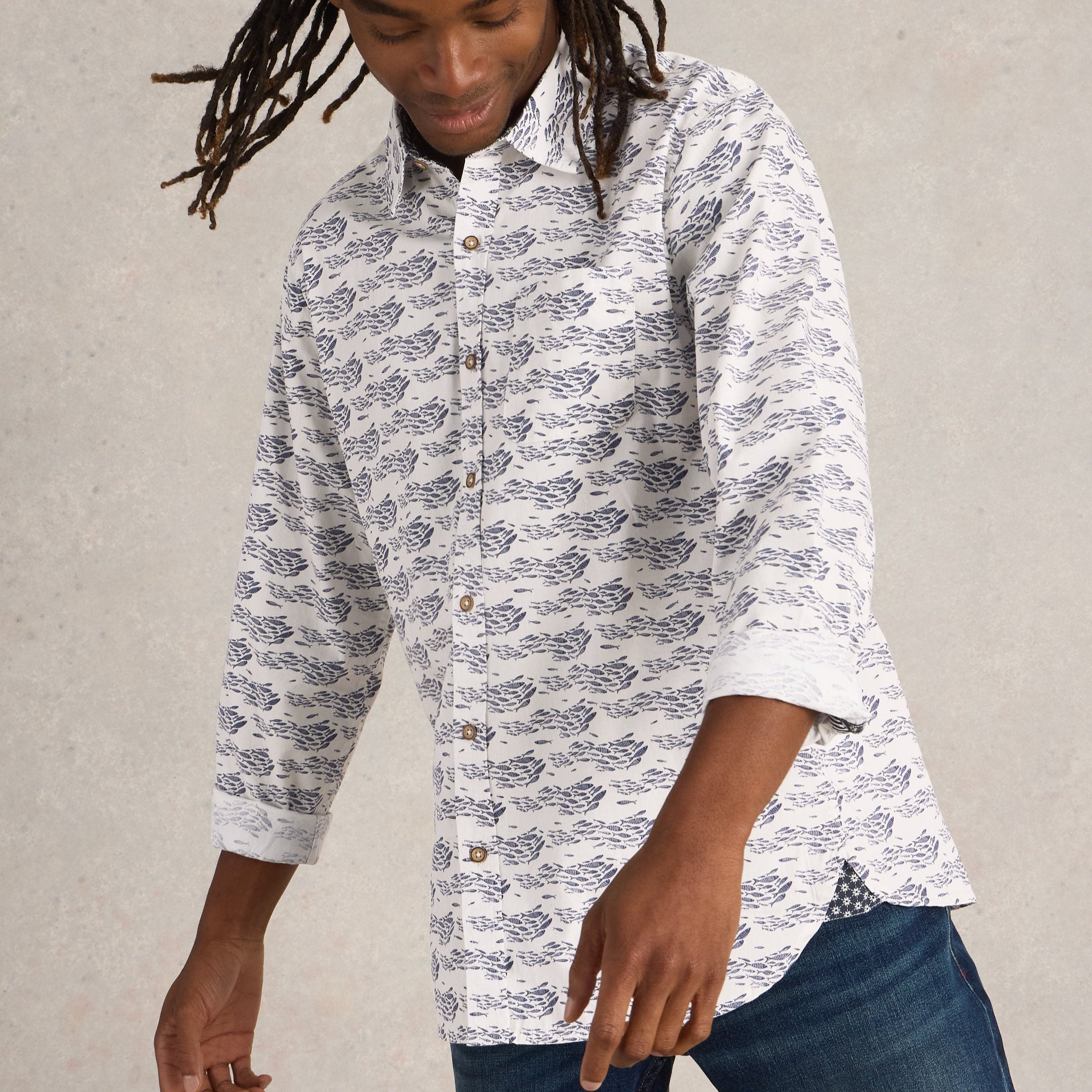 Off-white long-sleeve button-down shirt with a repeating pattern of dark-blue schools of fish.