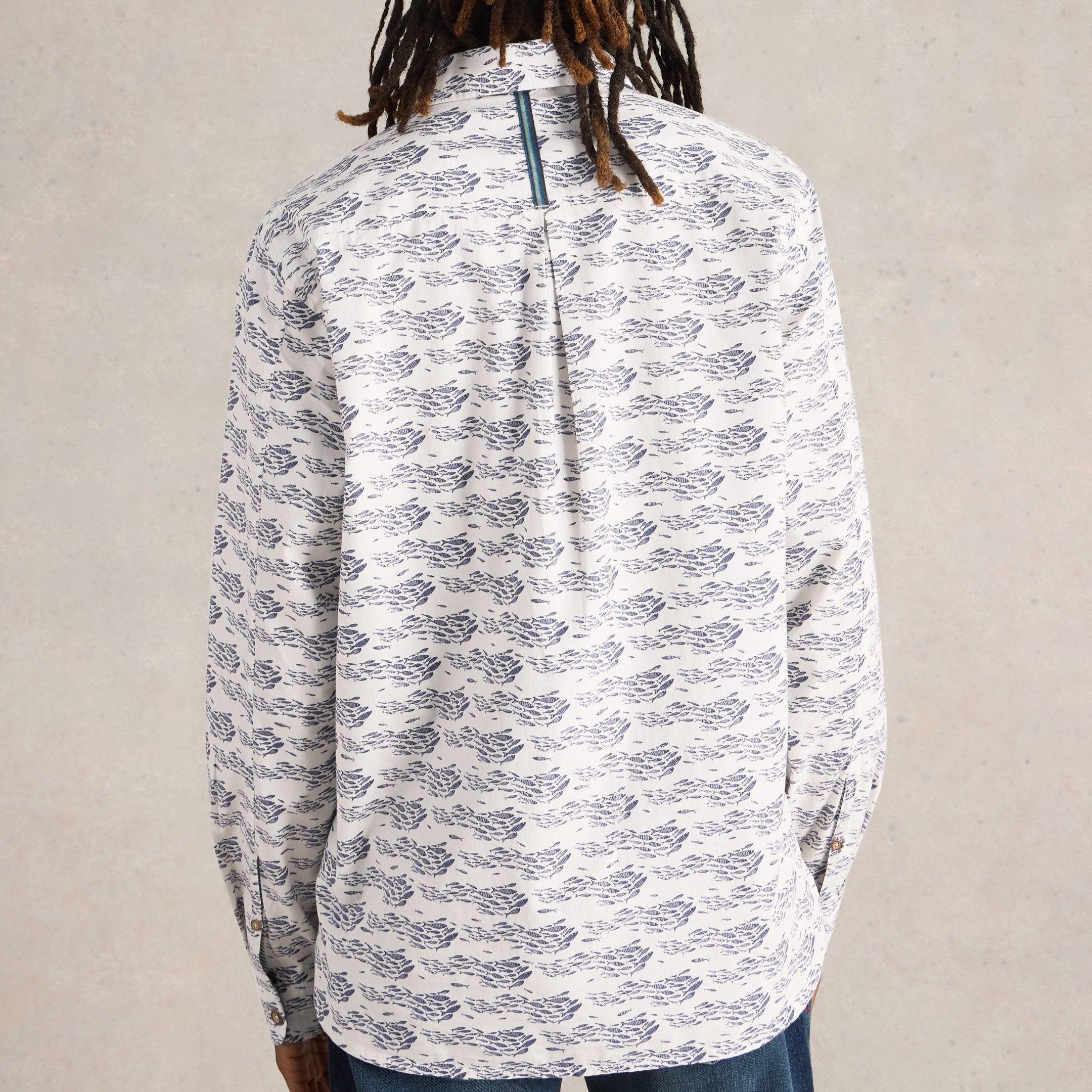Off-white long-sleeve button-down shirt with a repeating pattern of dark blue schools of fish.