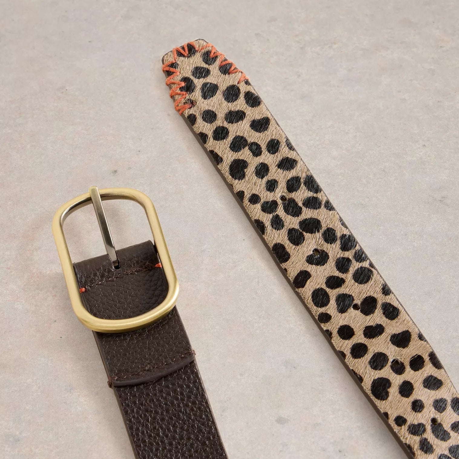 Brown leather belt with gold buckle and a contrasting beige and black leopard print section.