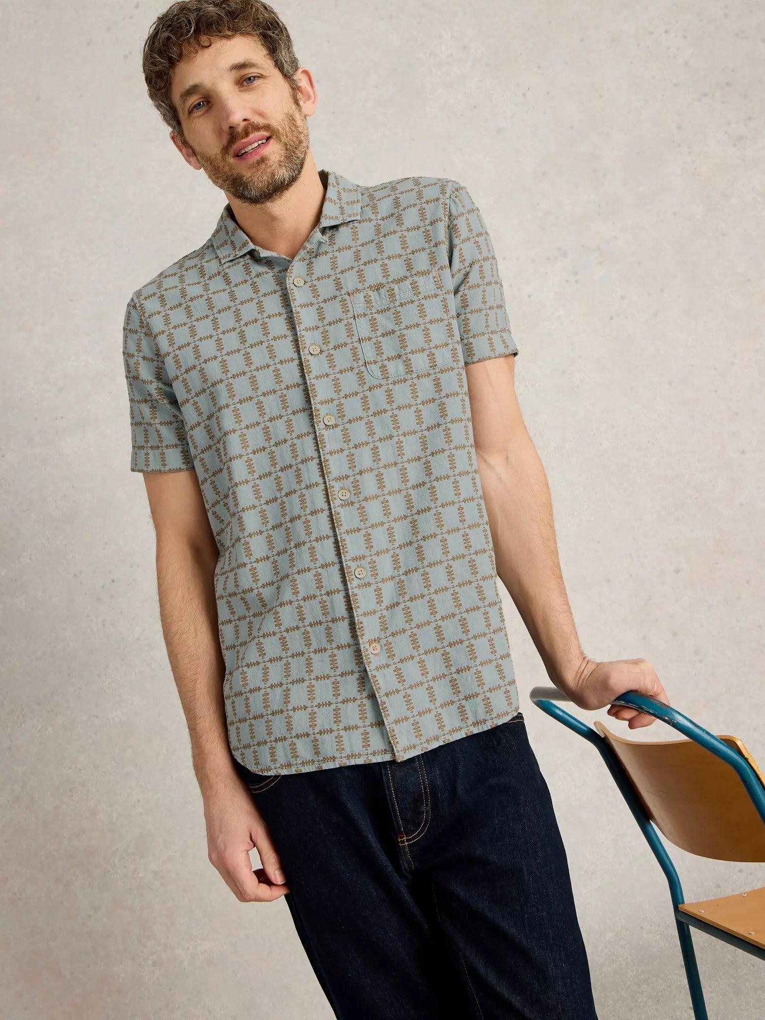 Men's short-sleeve shirt in teal with a brown geometric pattern.