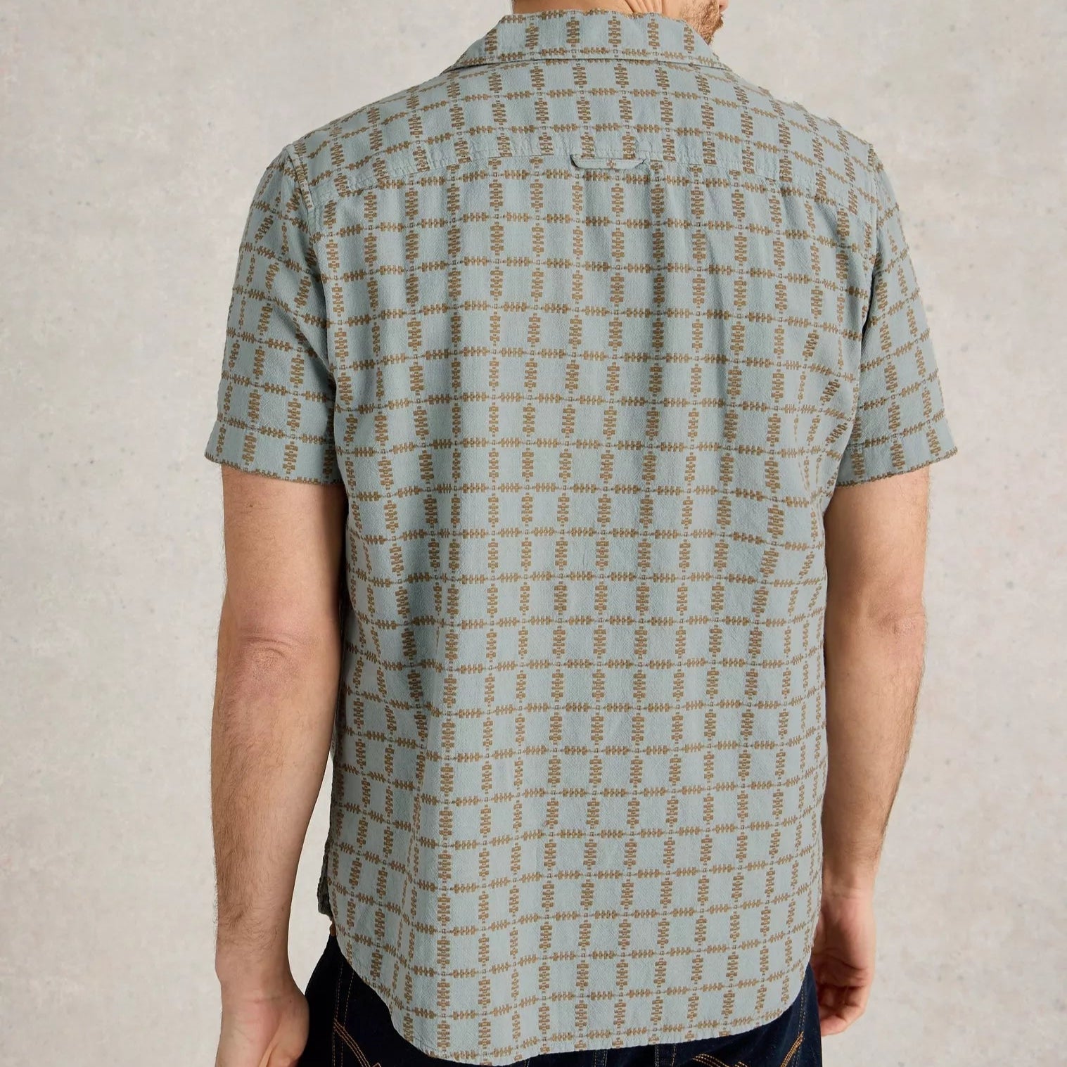 Men's short-sleeve button-down shirt in teal with a repeating geometric pattern in brown.