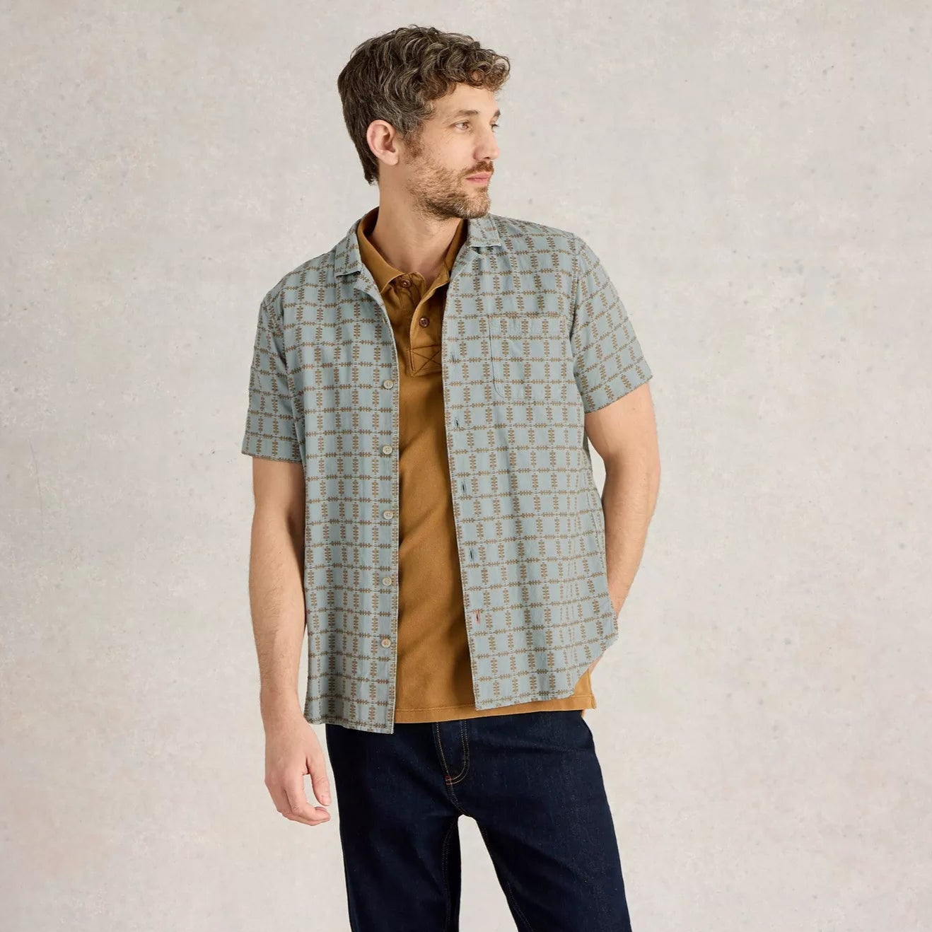 Men's short-sleeve button-down shirt in light blue with a brown geometric pattern.