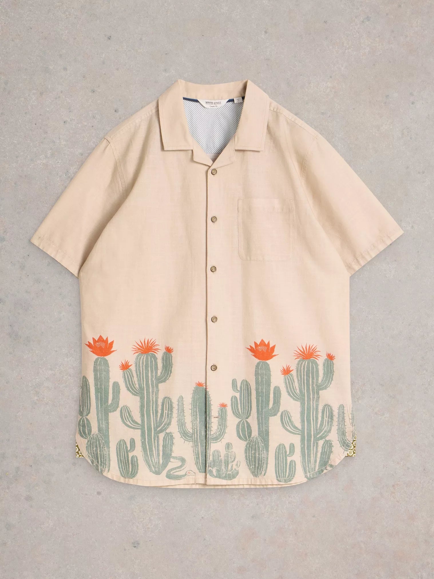 Beige short-sleeved button-down shirt with a cactus print at the hem.