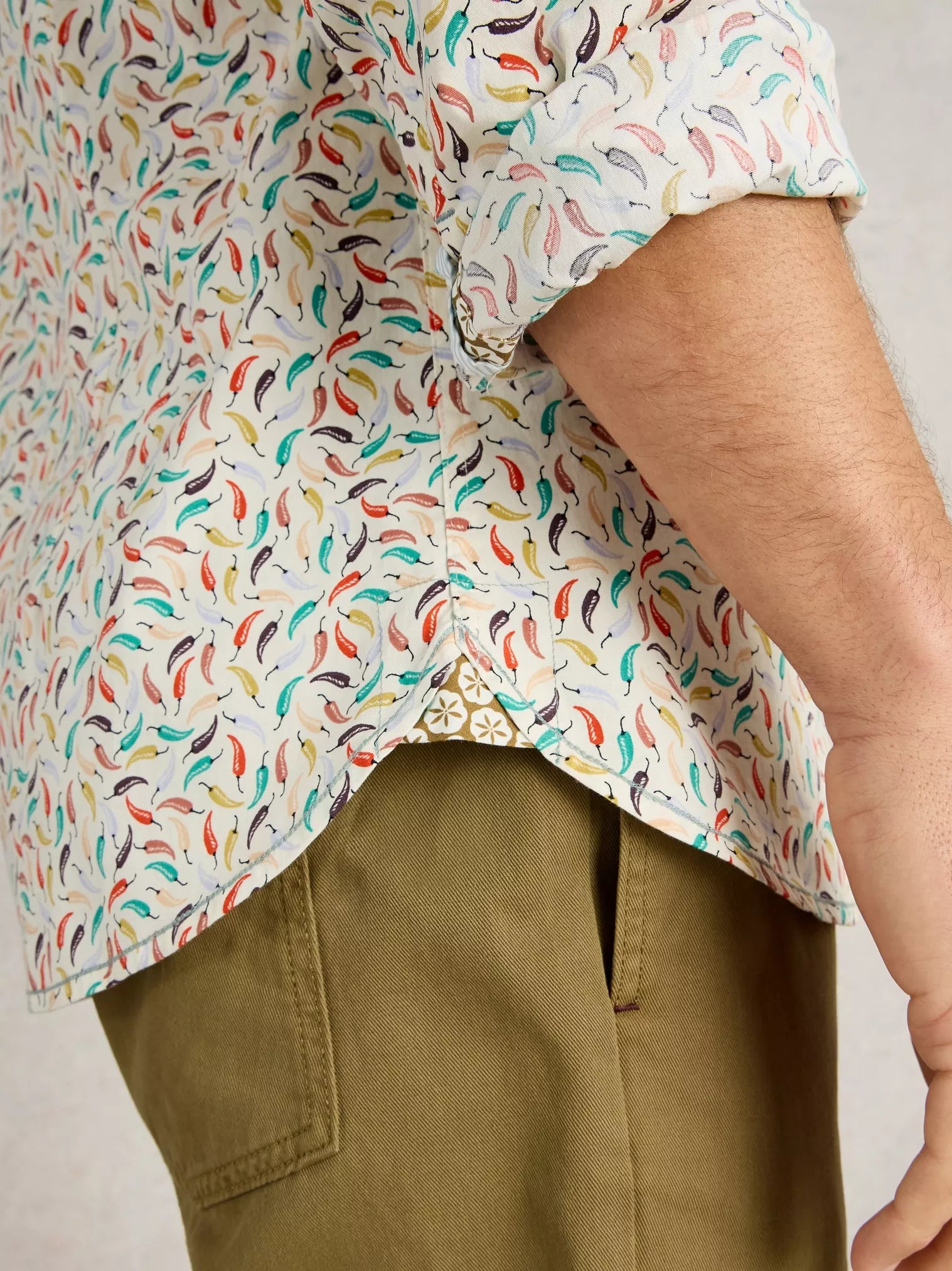 Men's long-sleeved shirt with an all-over chili pepper print on a cream background.