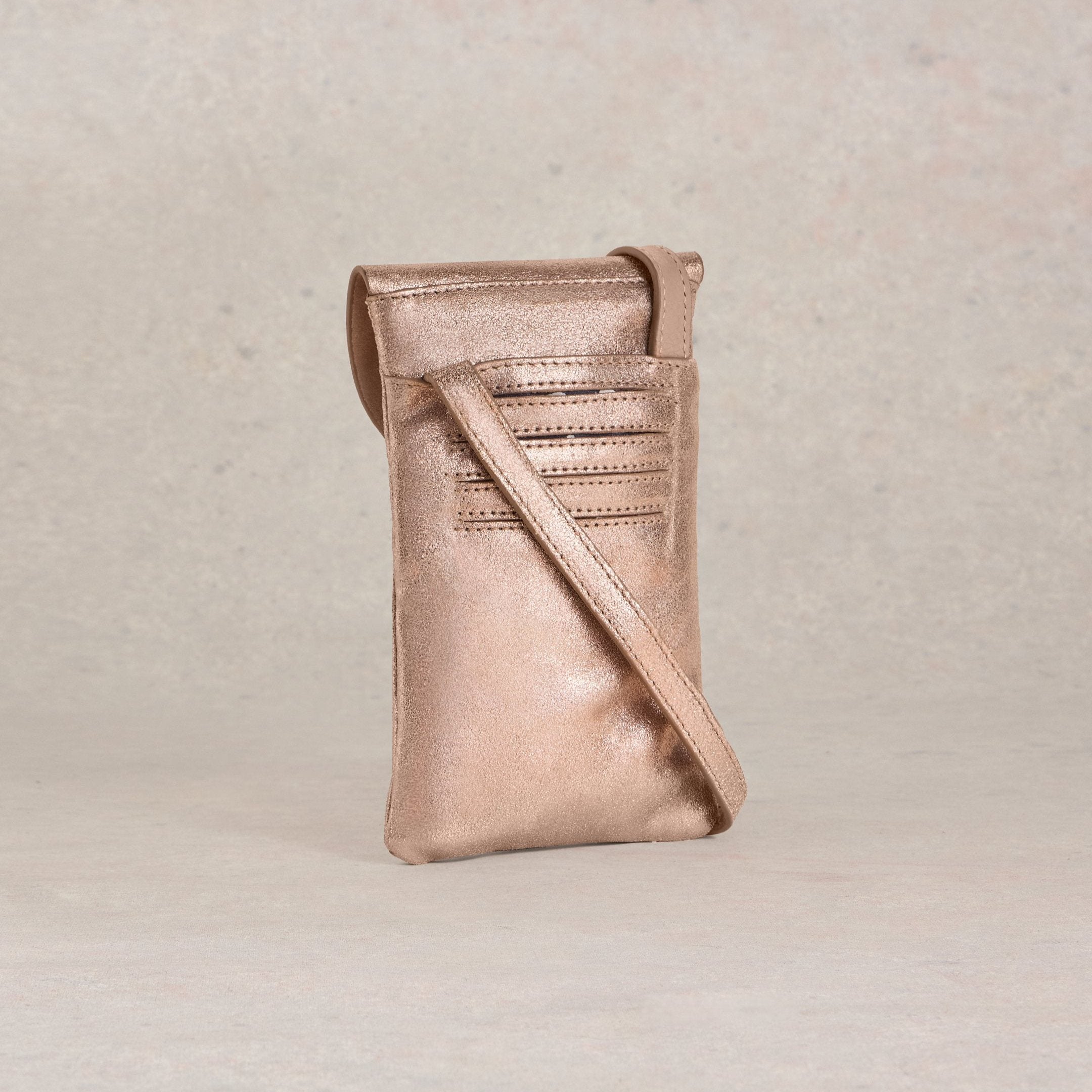 Rose gold metallic leather crossbody phone bag with a shoulder strap and card slots.