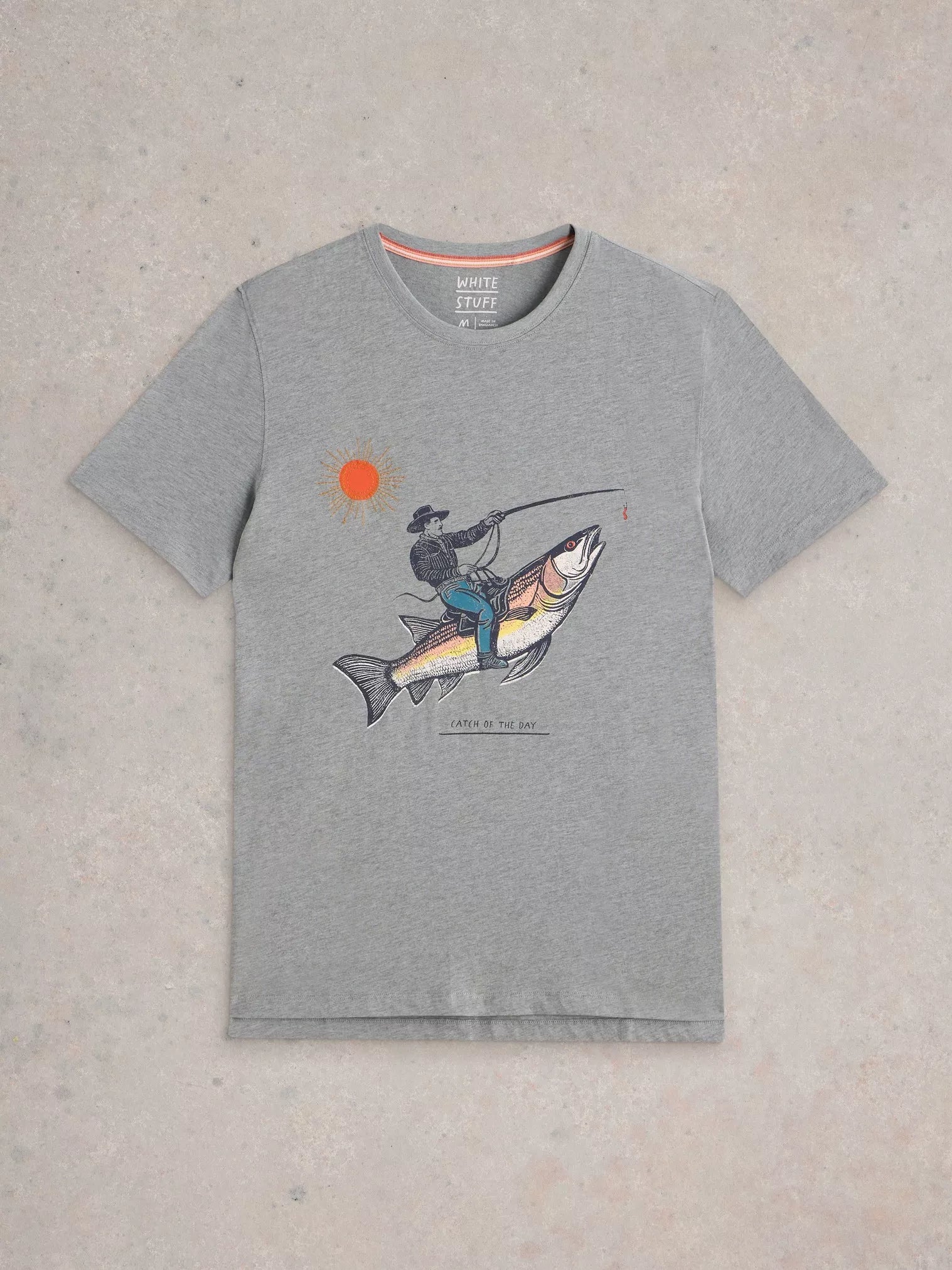 Grey short-sleeved t-shirt featuring a graphic print of a cowboy riding a large fish, under a sun.