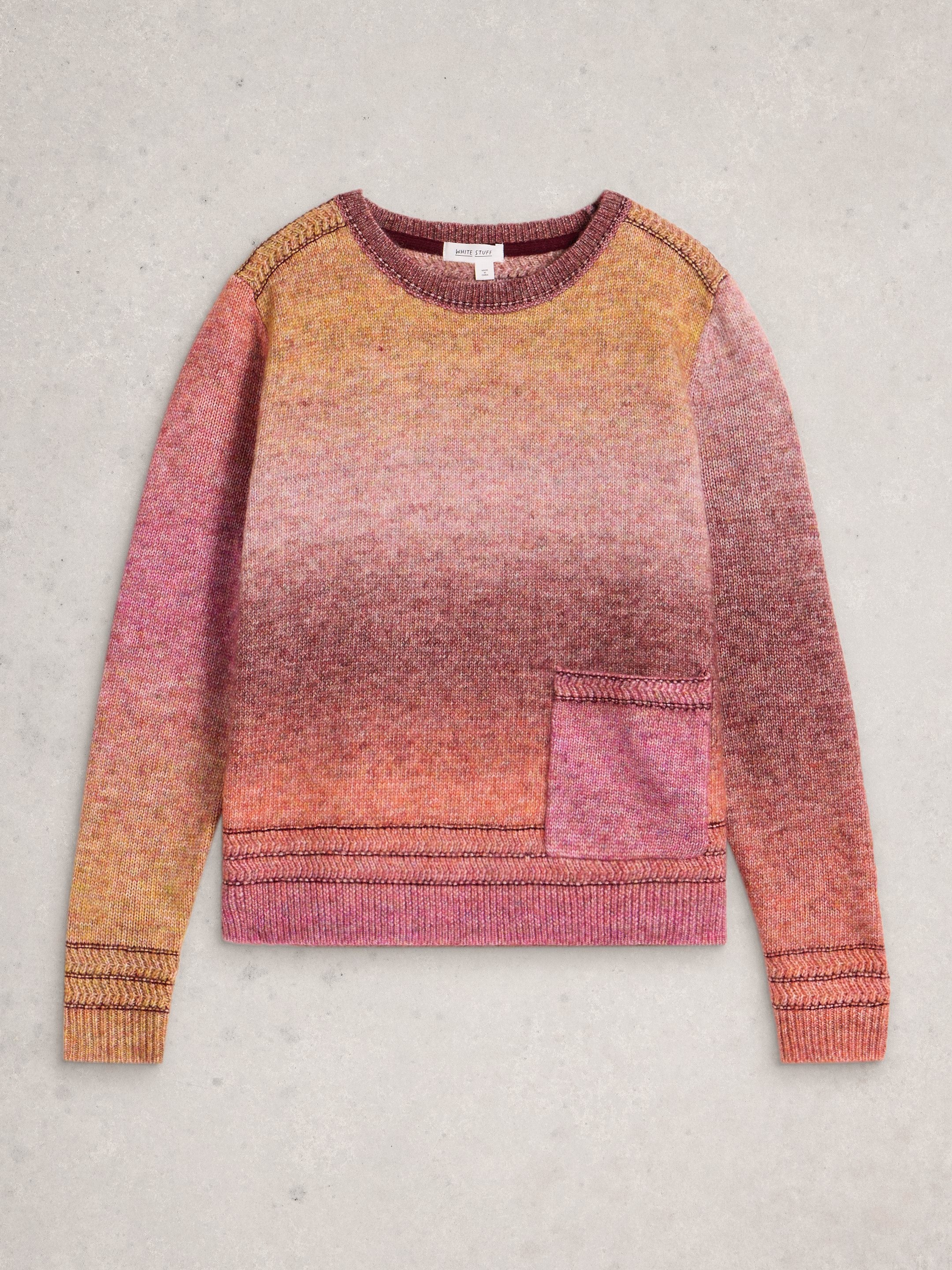 Gradient sweater with pink and orange colors on a gray background
