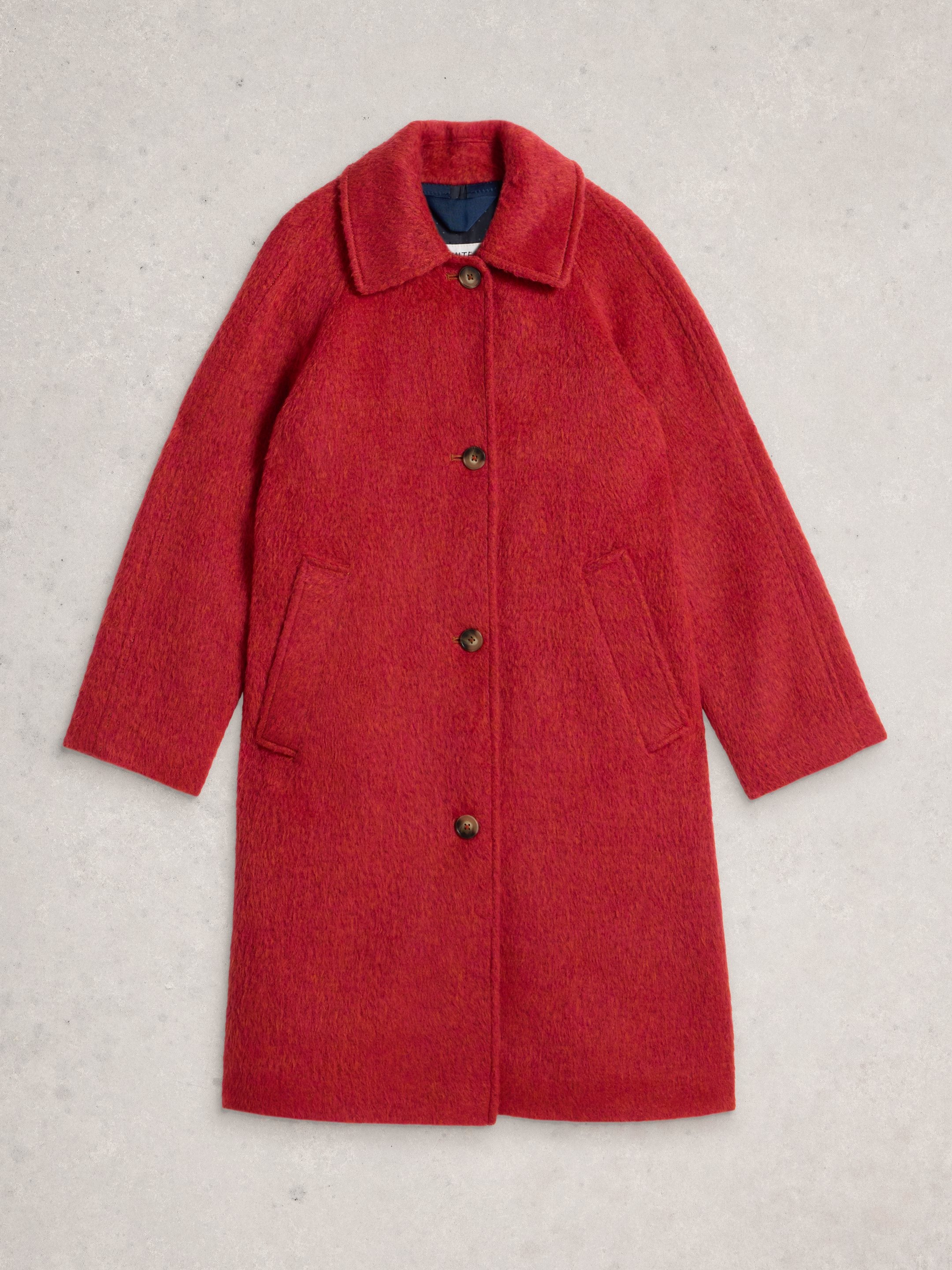 Red coat with buttons on a light gray background