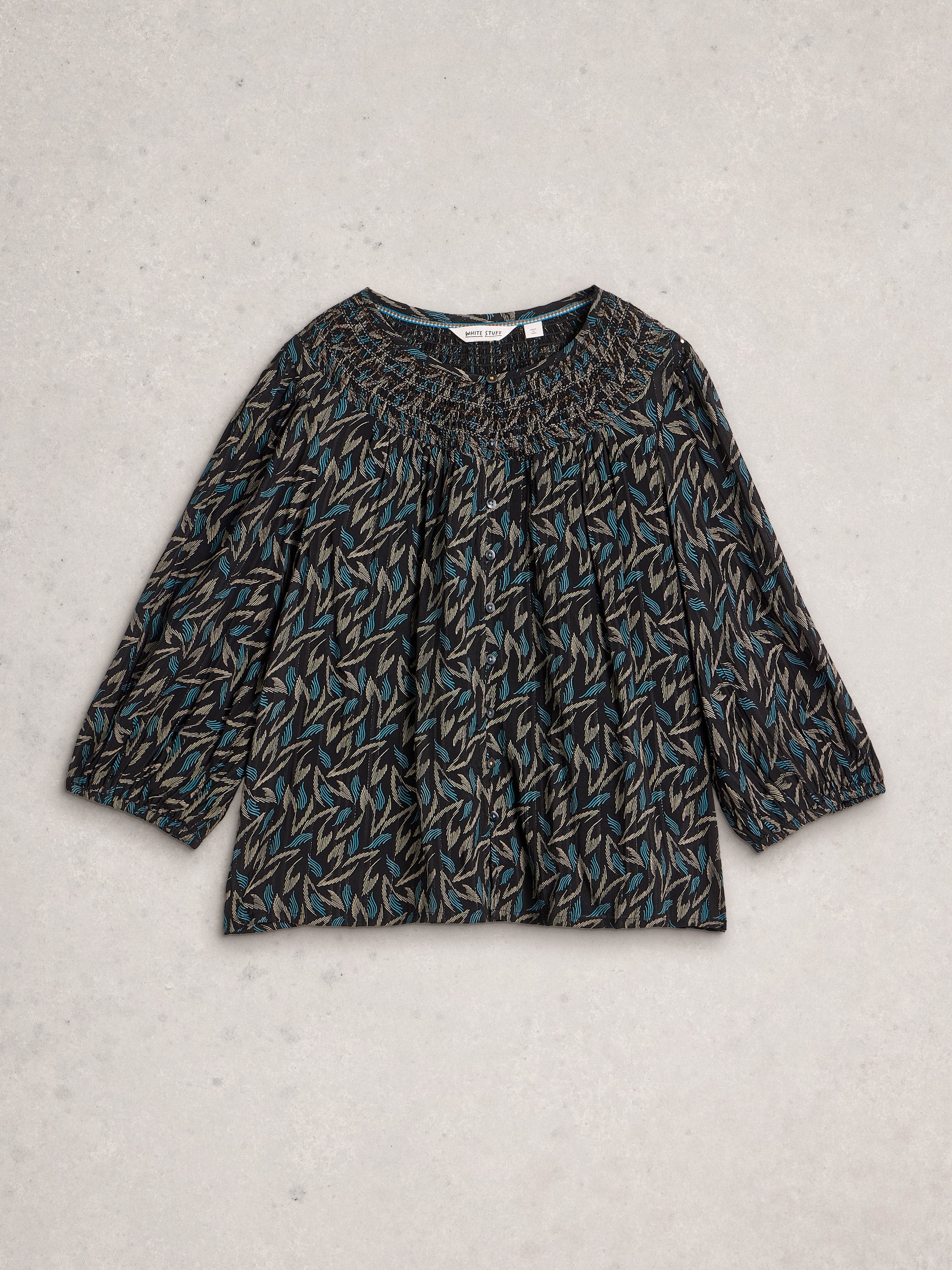 Long-sleeve top with a leaf pattern on a light gray background