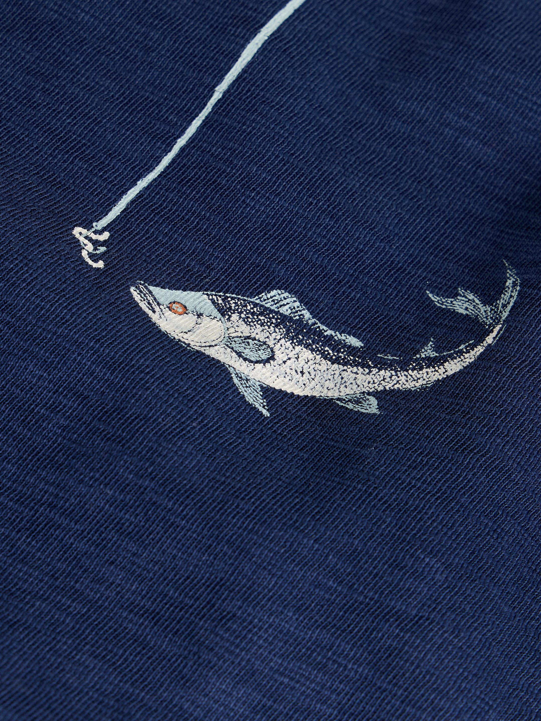 Embroidered fish design on a navy blue fabric