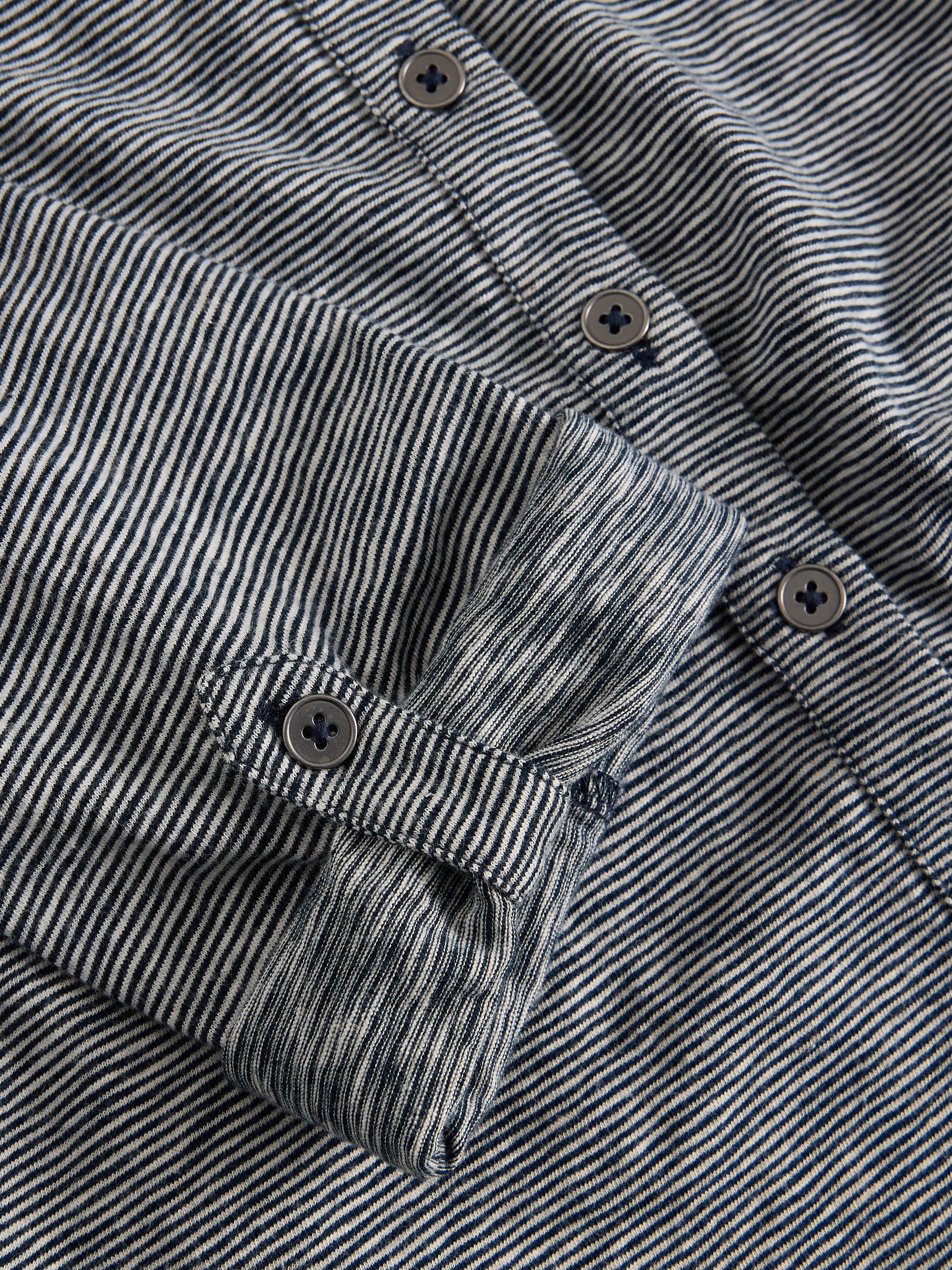 Close-up of a black and white striped shirt with buttons