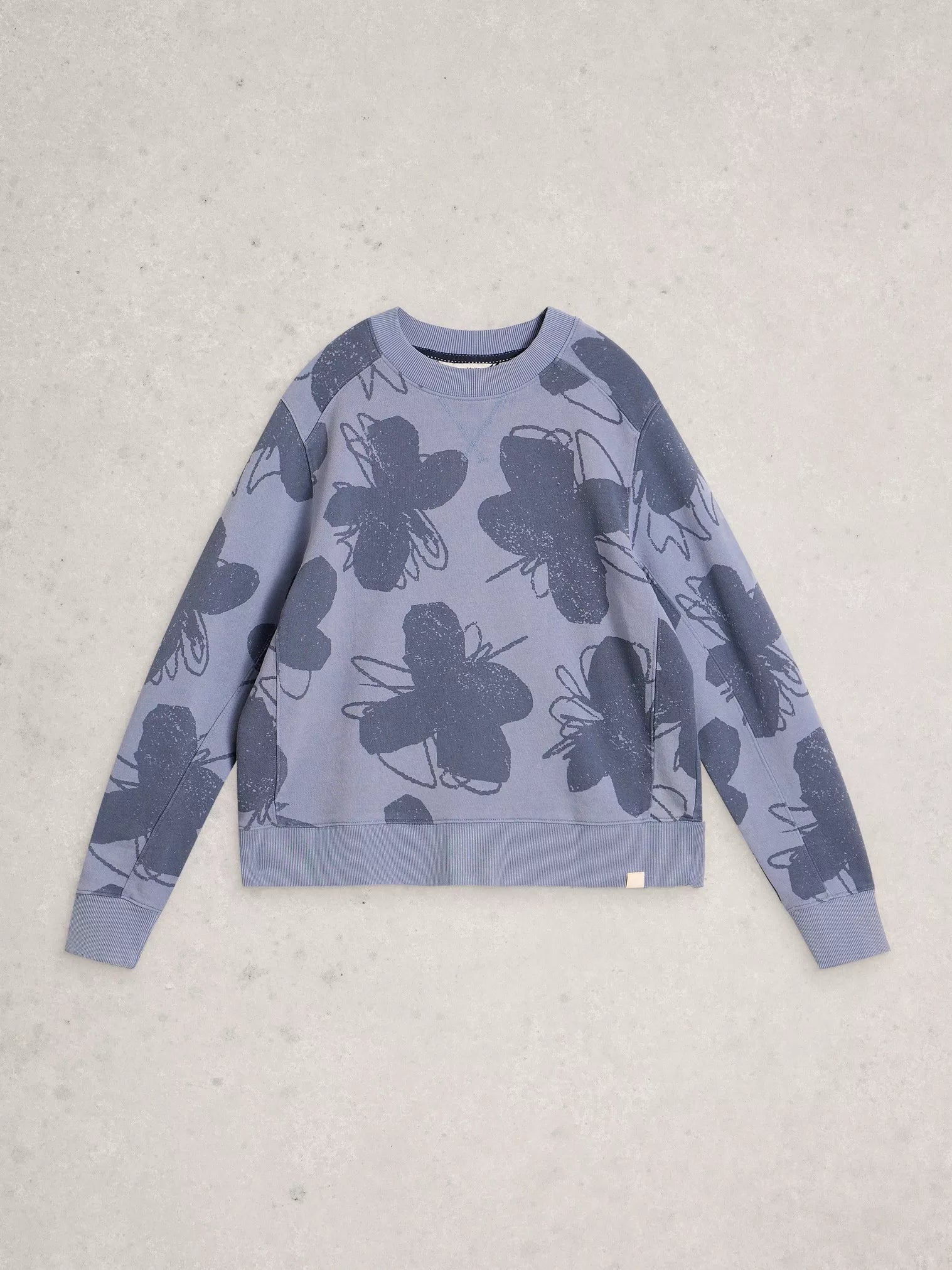 Blue sweater with butterfly pattern on a light gray background