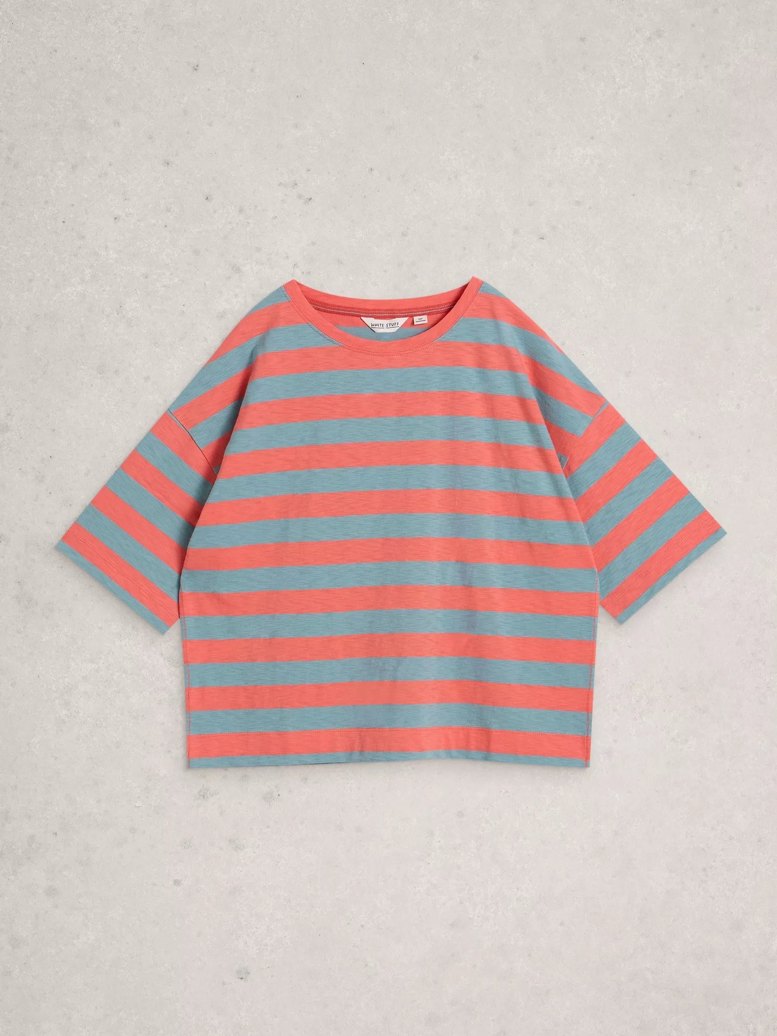 Striped shirt with red and blue horizontal stripes on a light gray background