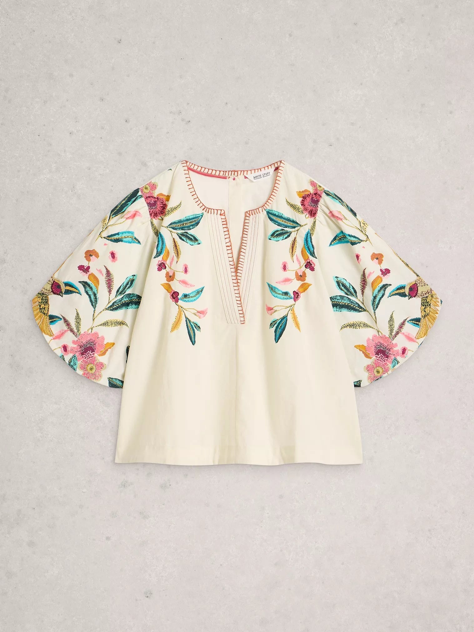 Floral embroidered blouse on a light gray background