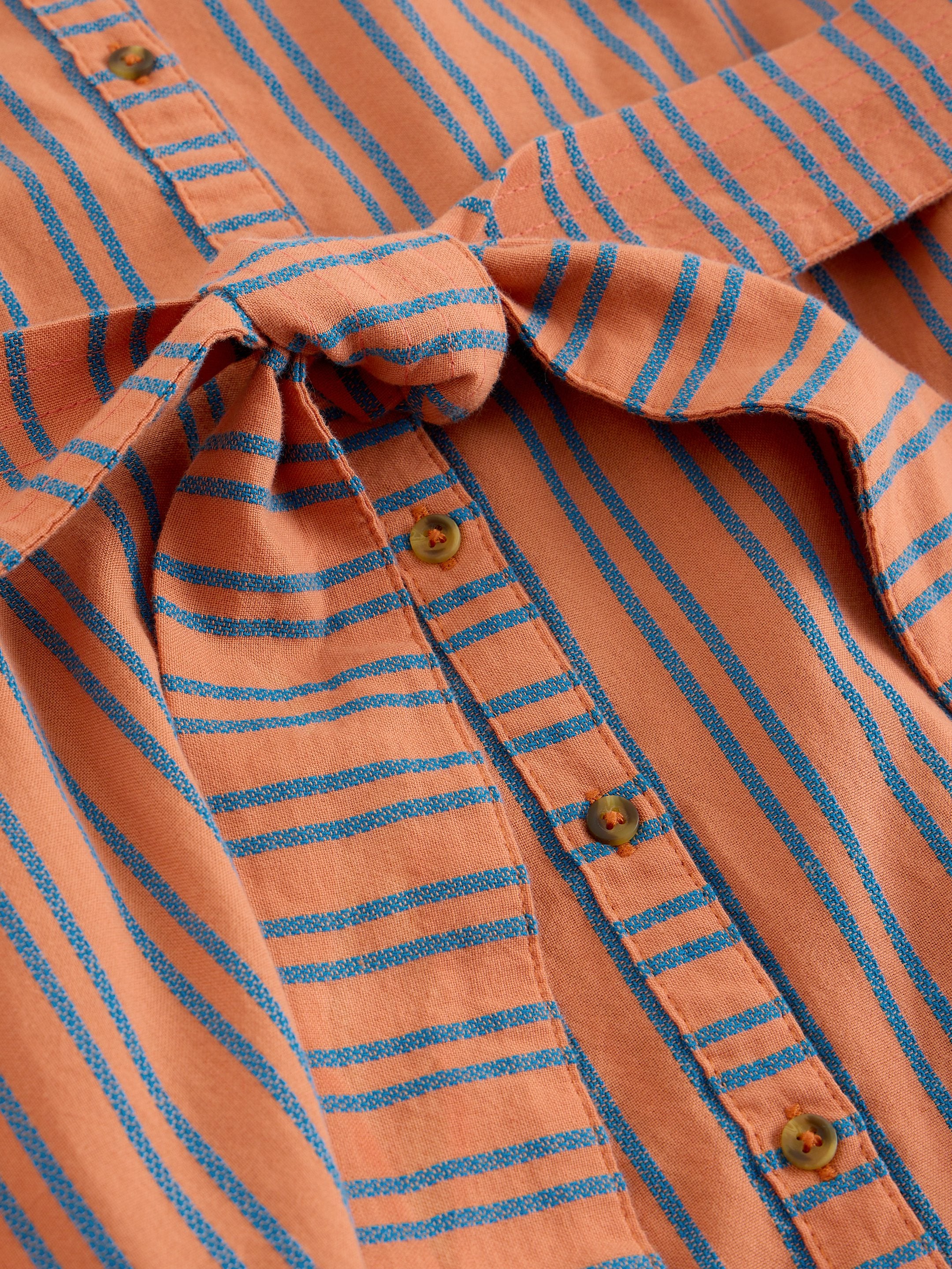 Close-up of an orange and blue striped shirt with a tie detail.