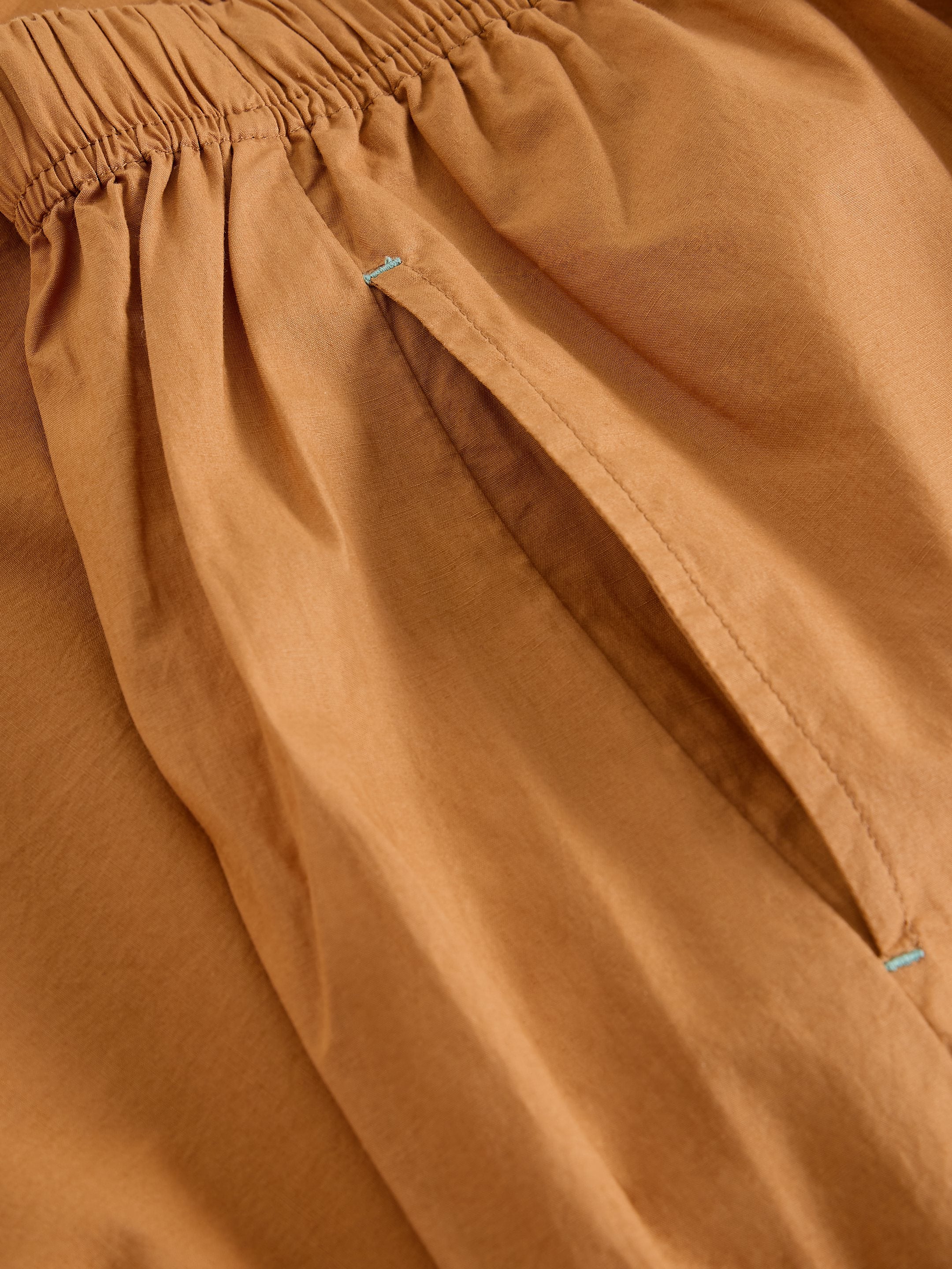 Close-up of brown fabric with a subtle texture
