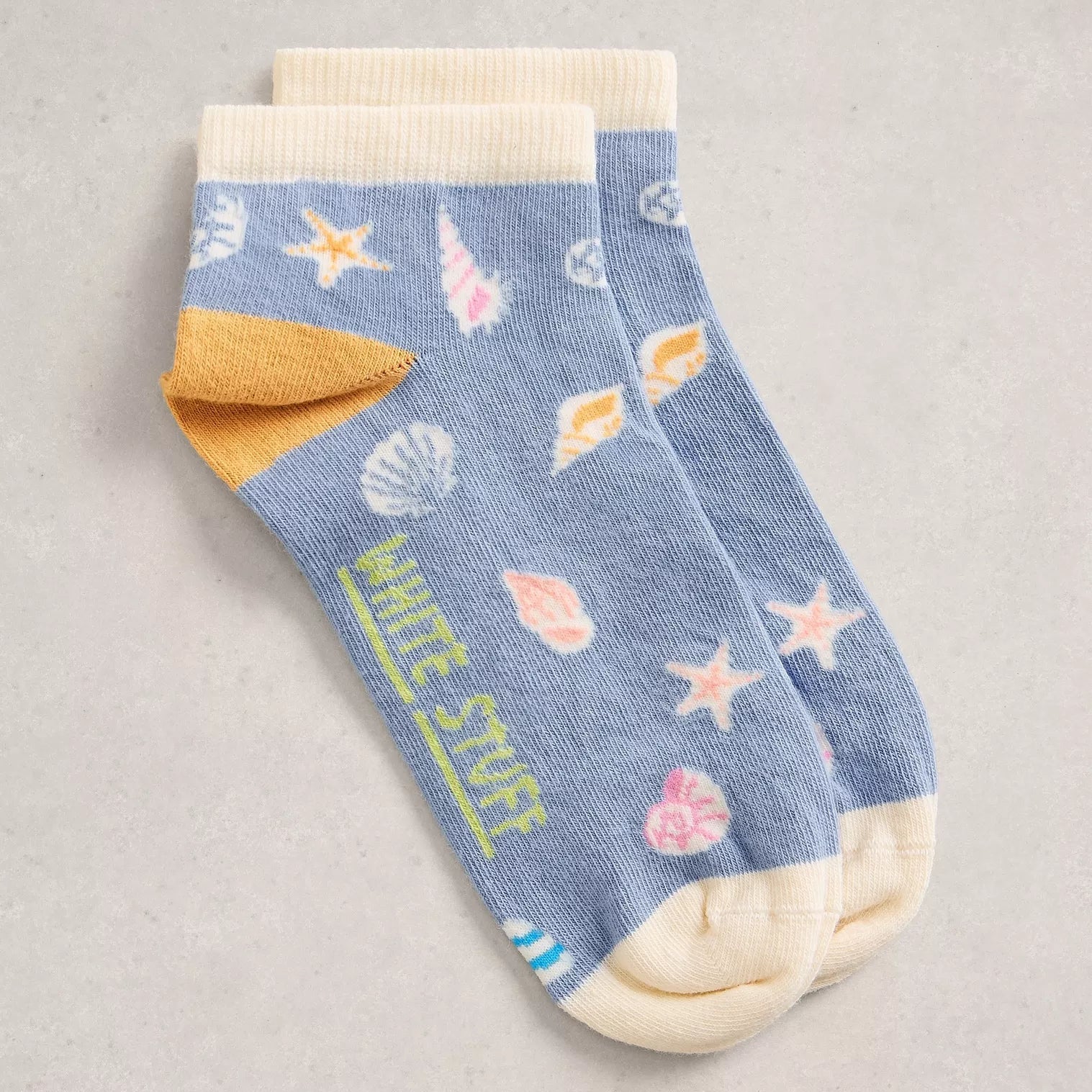 Blue ankle sock with sea-themed design on a gray background