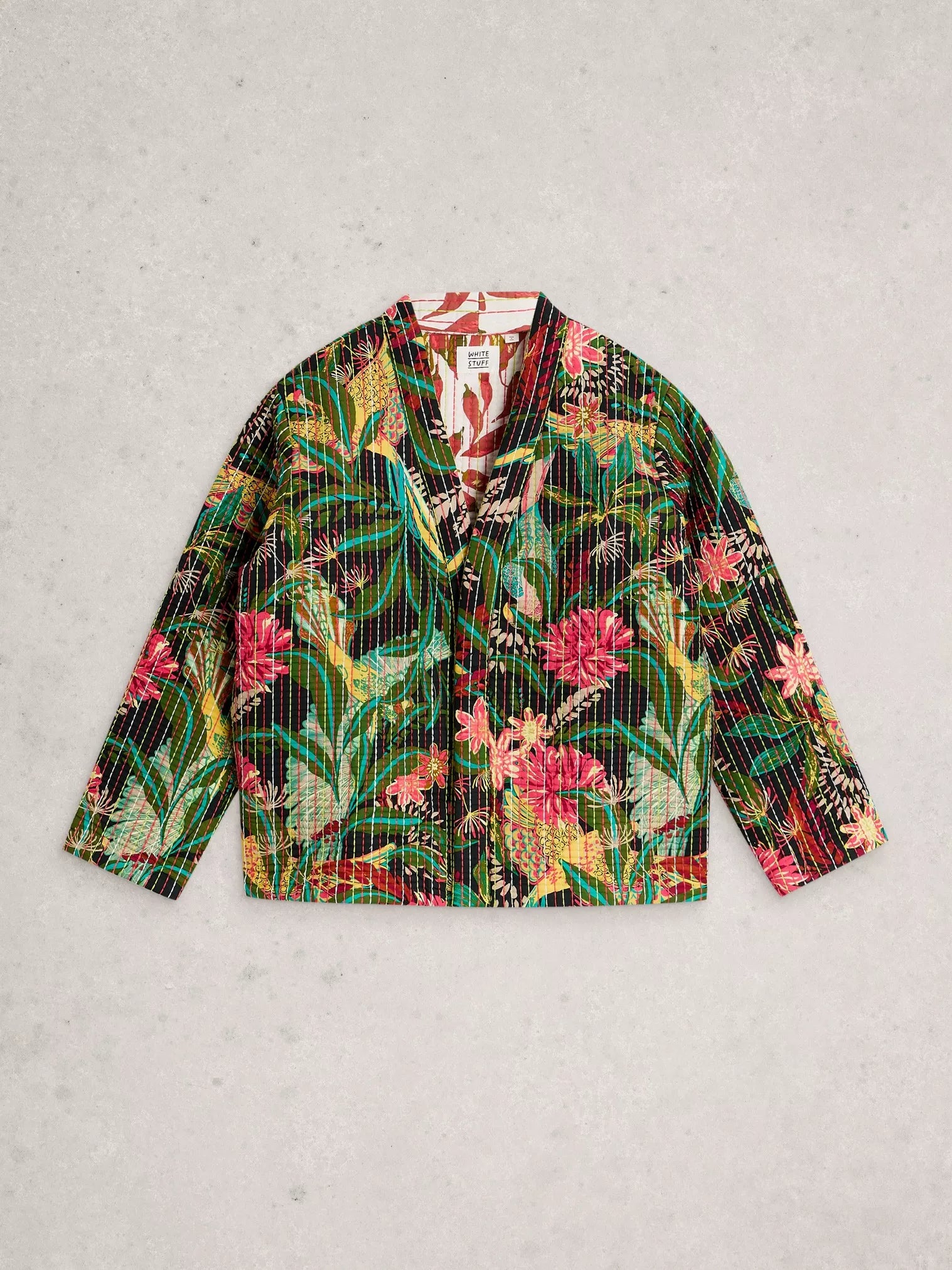 Colorful floral-patterned shirt on a light gray background
