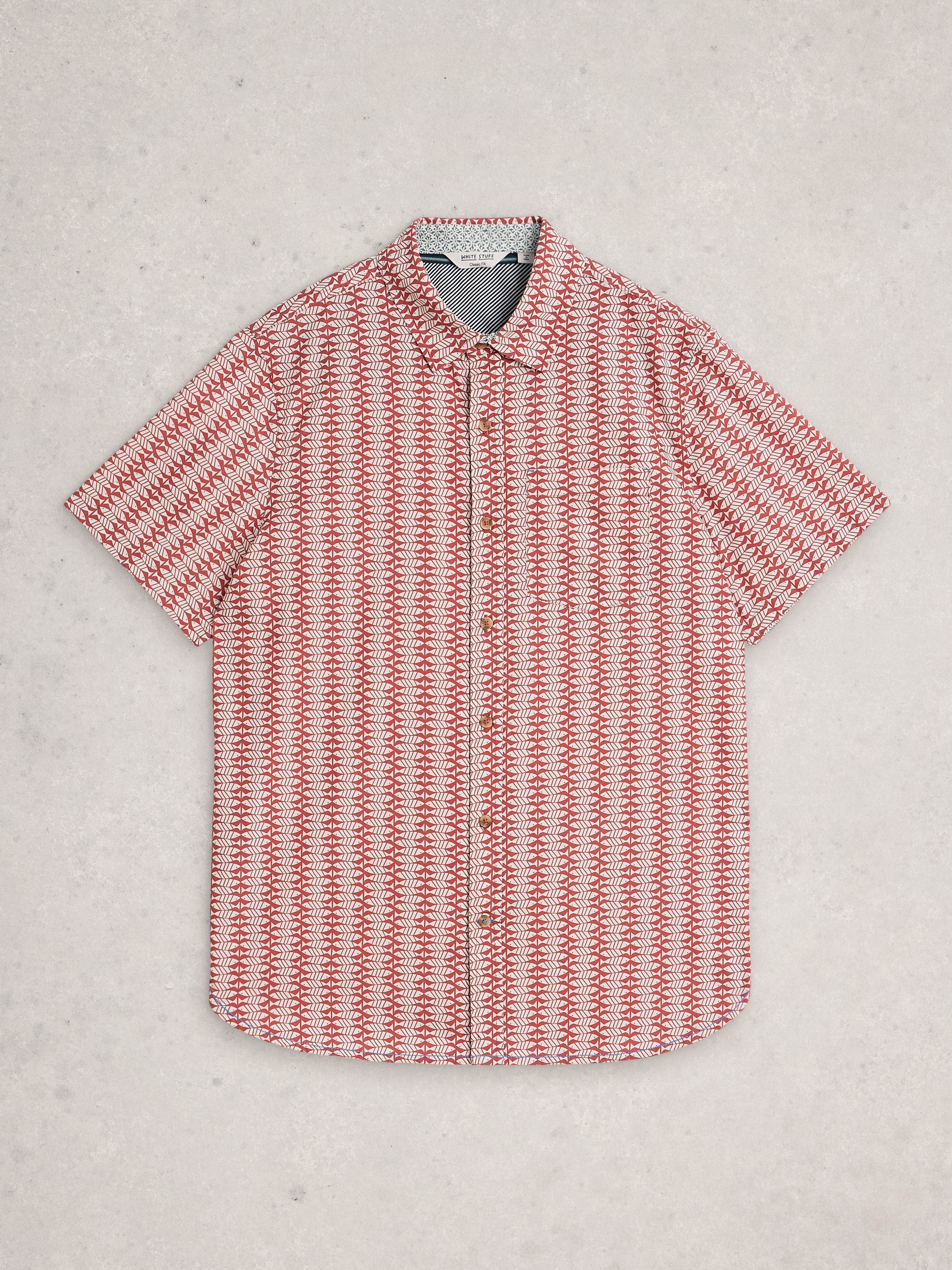 Red and white patterned shirt on a light gray background