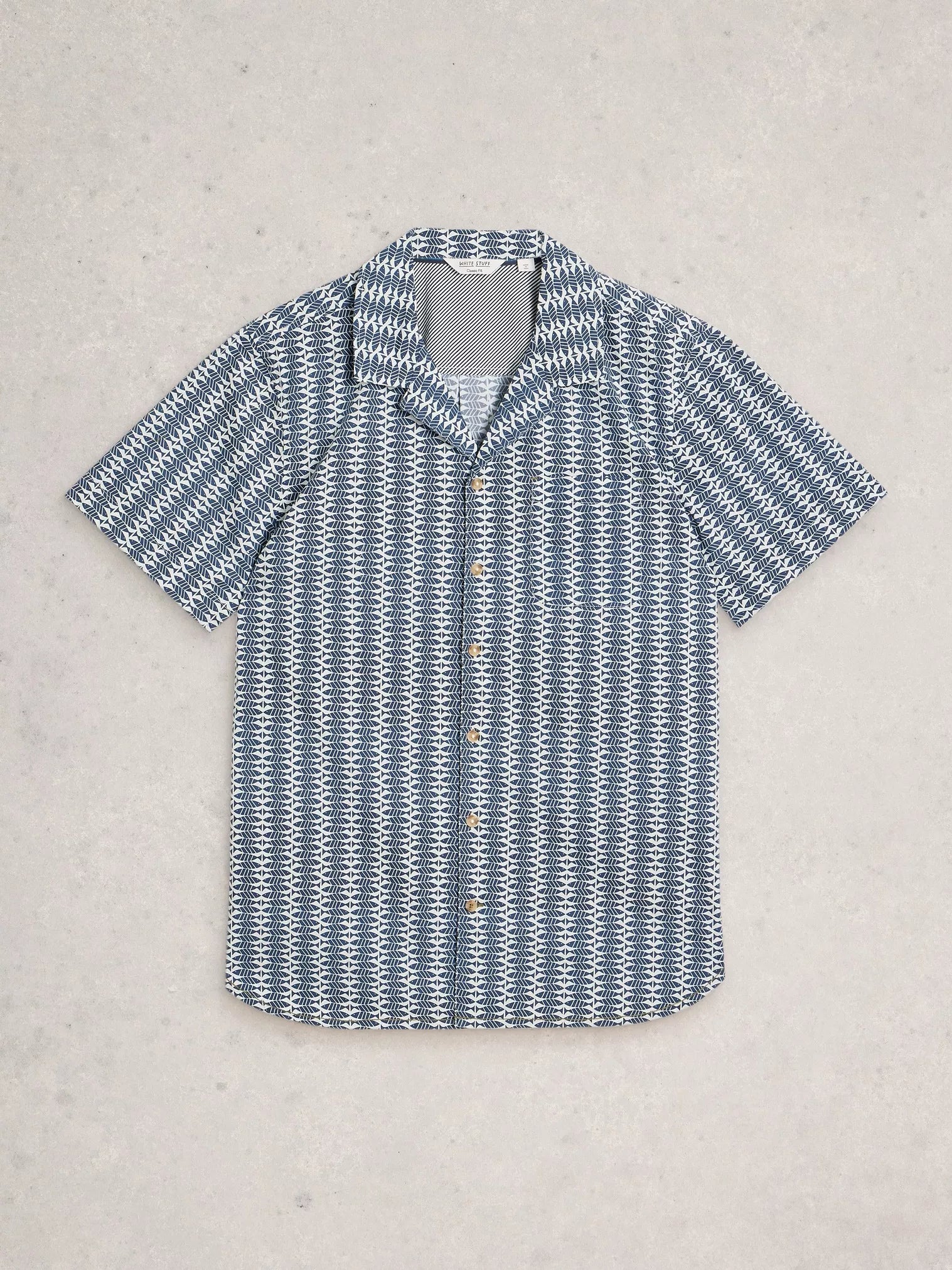 Blue and white patterned shirt on a light gray background