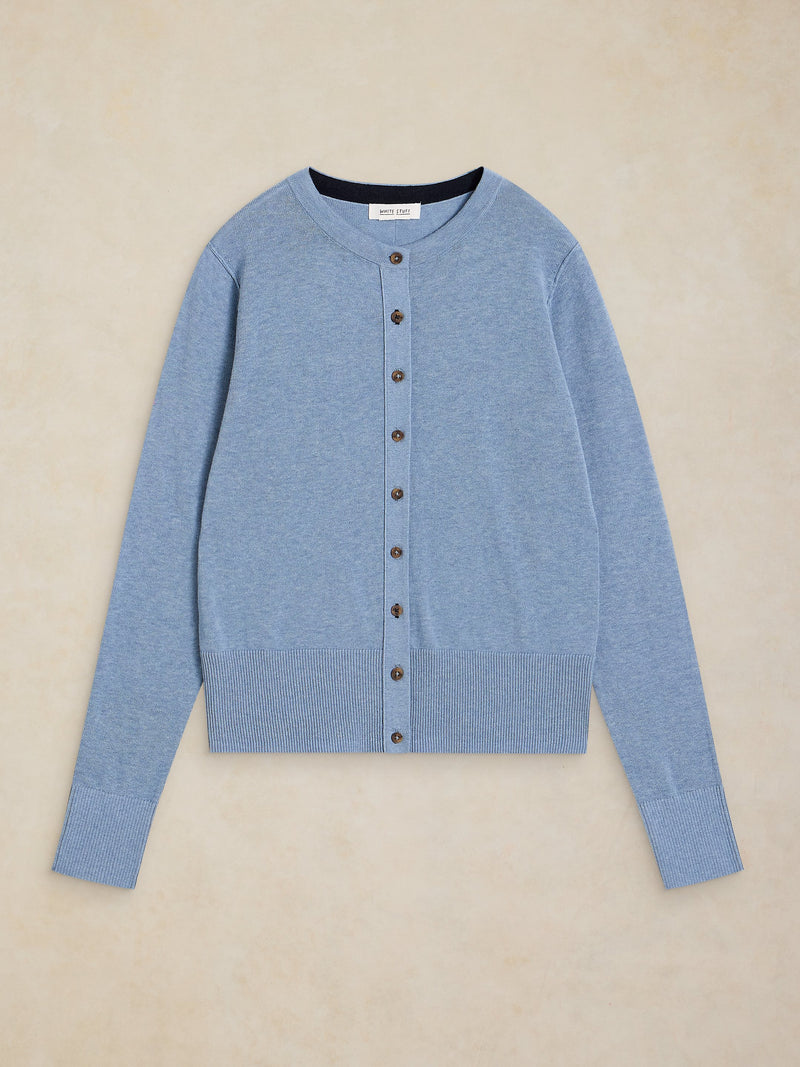 Blue cardigan with buttons on a beige background