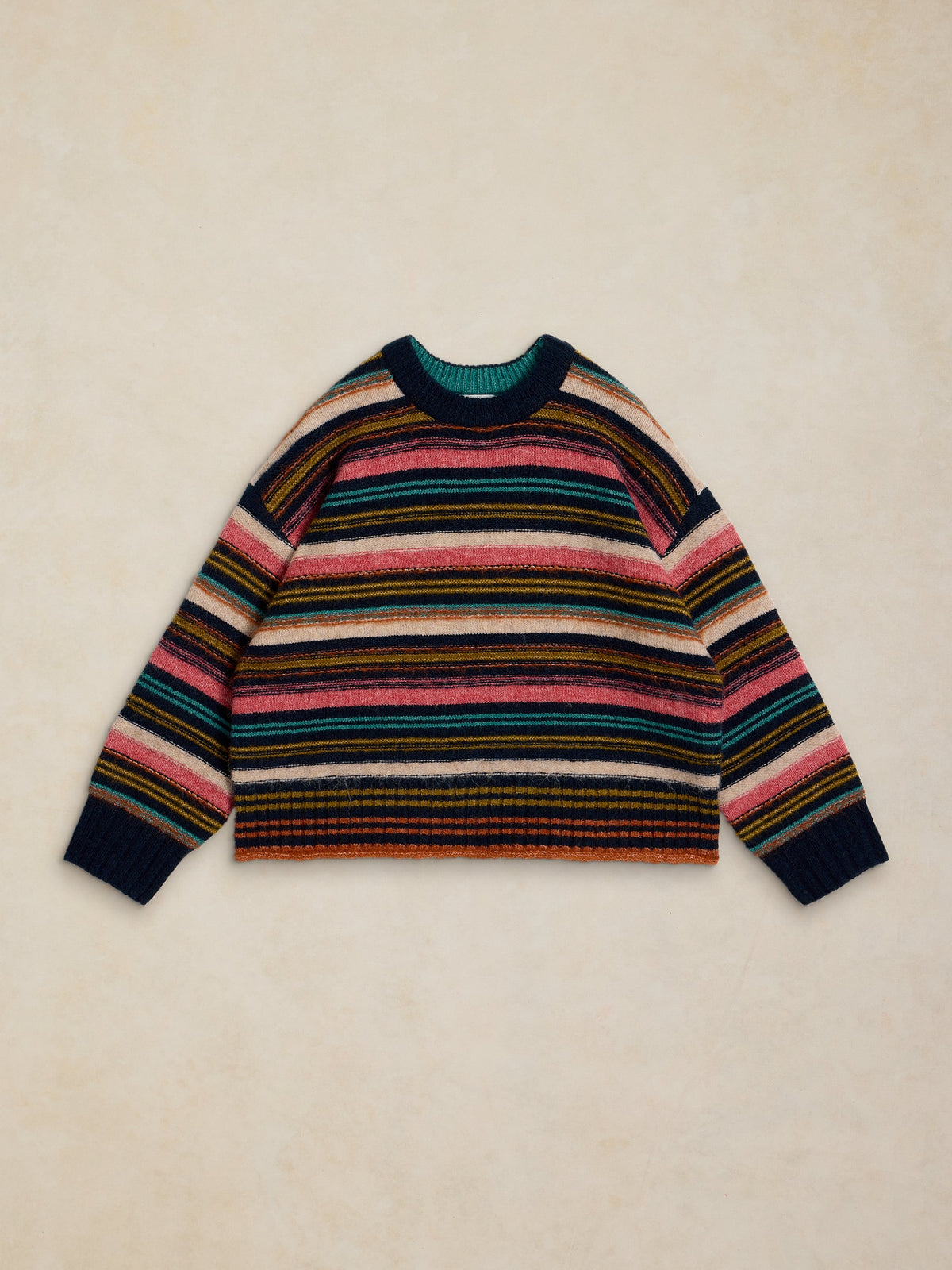 Multicolored striped sweater on a beige background