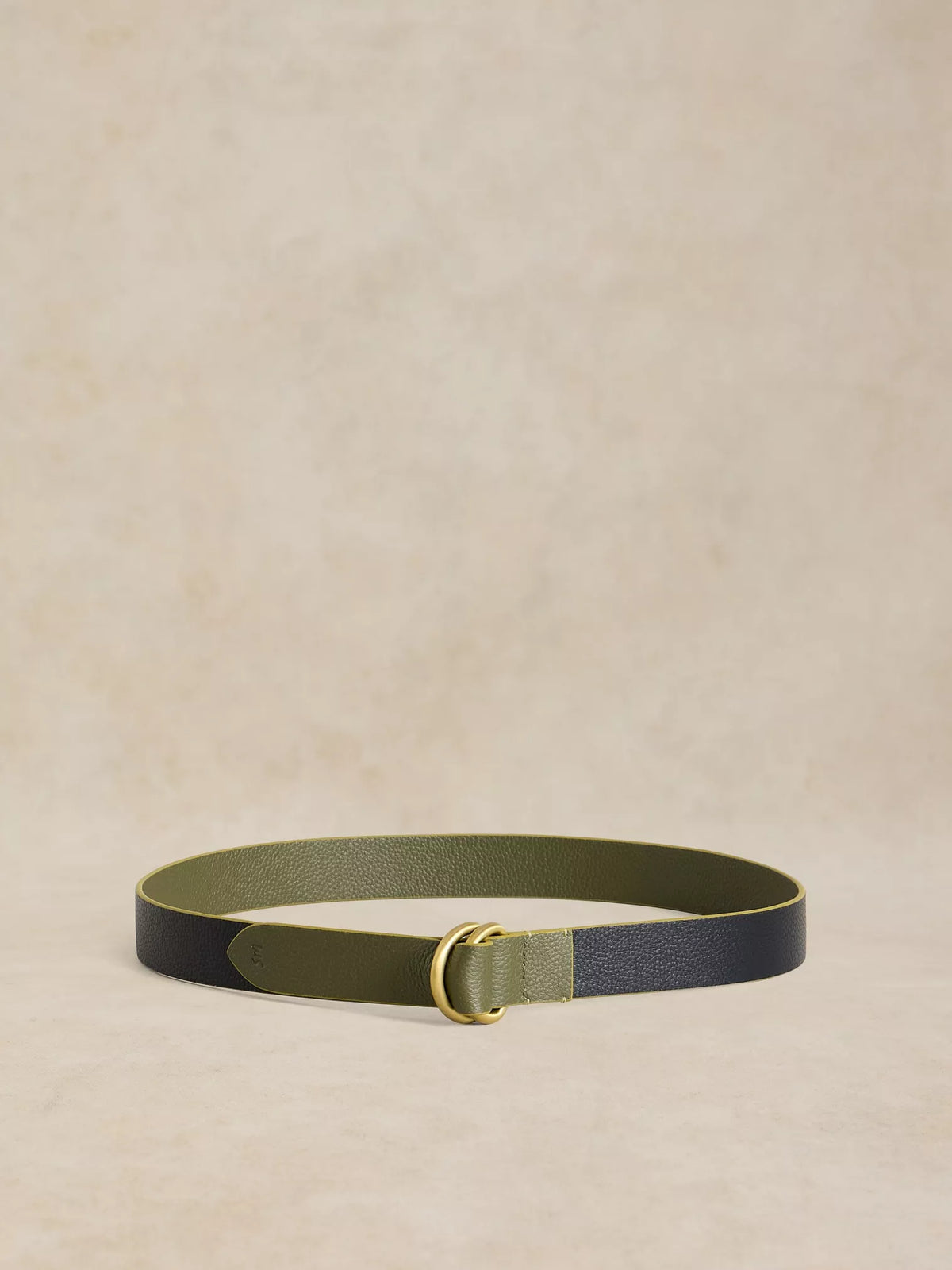 A slim leather belt with a color-blocked design in olive green and dark navy blue, featuring a gold-tone metal buckle, displayed on a textured beige background.