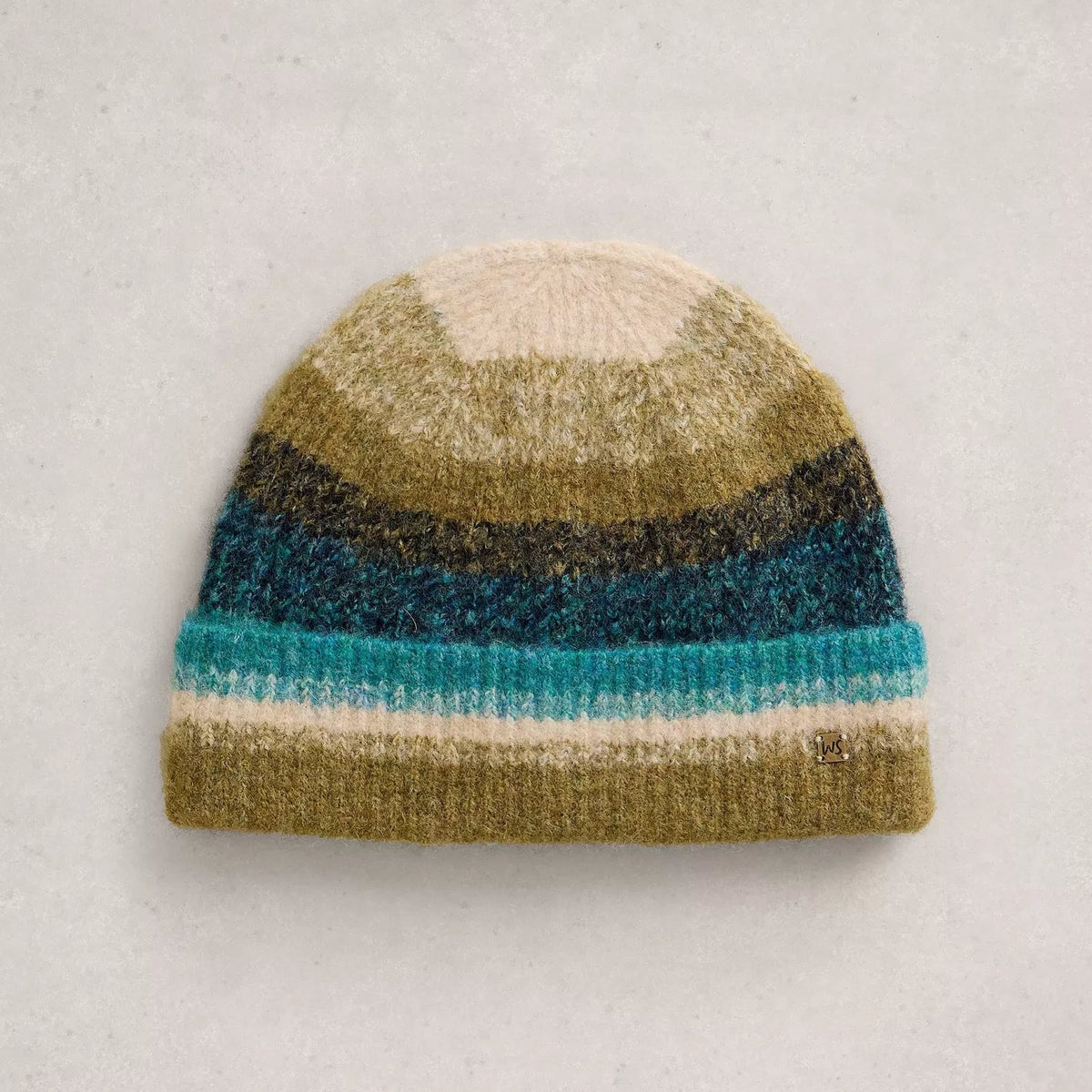 A striped knit beanie hat in horizontal bands of cream, olive green, dark charcoal, teal blue, and light aqua, displayed flat against a light gray textured background.