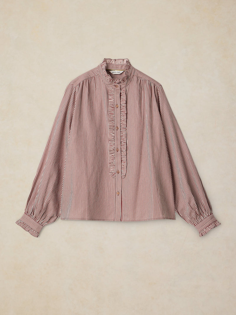 Pink and white striped blouse on a beige background