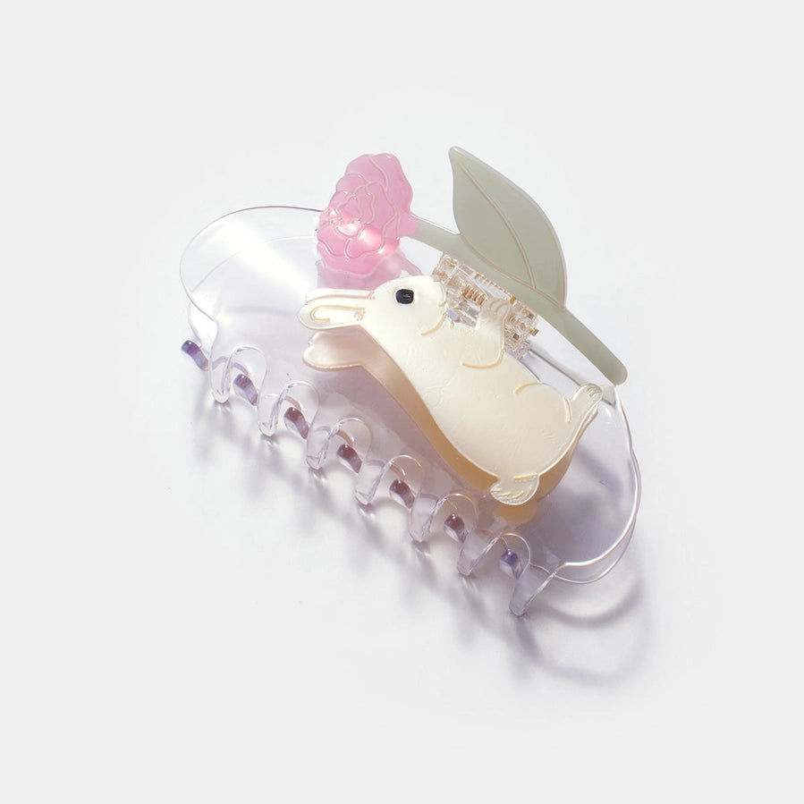 Decorative hair clip with a cartoon duck design on a white background