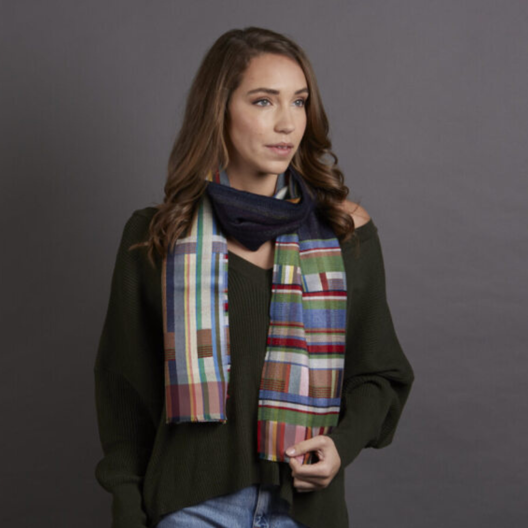 Multicolored striped and plaid wool scarf with a navy blue base layer.